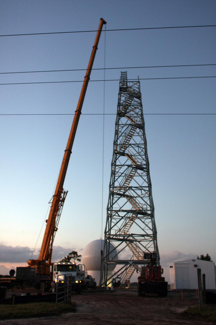 CAPE CANAVERAL, Fla. - A crane is prepared to lift the radome to the top of a new Doppler weather radar tower being built in an area near S.R. 520 in Orange County, Fla. The dome houses the weather radar dish and pedestal and protects them from the elements.  The new tower will replace one at nearby Patrick Air Force Base and will be used by NASA's Kennedy Space Center, the 45th Space Wing and their customers. The tower will be able to monitor weather conditions directly above the launch pads at Kennedy. The weather radar is essential in issuing lightning and other severe weather warnings and vital in evaluating lightning launch commit criteria. The new radar, replacing what was installed 25 years ago, includes Doppler capability to detect winds and identify the type, size and number of precipitation particles. The site is ideally distant from the launch pads and has unobstructed views of Cape Canaveral Air Force Station and Kennedy. Photo credit: NASA/Dimitri Gerondidakis