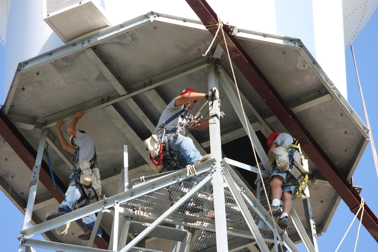 CAPE CANAVERAL, Fla. - Workers secure the radome to the top of a new Doppler weather radar tower being built in an area near S.R. 520 in Orange County, Fla. The dome houses the weather radar dish and pedestal and protects them from the elements.  The new tower will replace one at nearby Patrick Air Force Base and will be used by NASA's Kennedy Space Center, the 45th Space Wing and their customers. The tower will be able to monitor weather conditions directly above the launch pads at Kennedy. The weather radar is essential in issuing lightning and other severe weather warnings and vital in evaluating lightning launch commit criteria. The new radar, replacing what was installed 25 years ago, includes Doppler capability to detect winds and identify the type, size and number of precipitation particles. The site is ideally distant from the launch pads and has unobstructed views of Cape Canaveral Air Force Station and Kennedy. Photo credit: NASA/Dimitri Gerondidakis