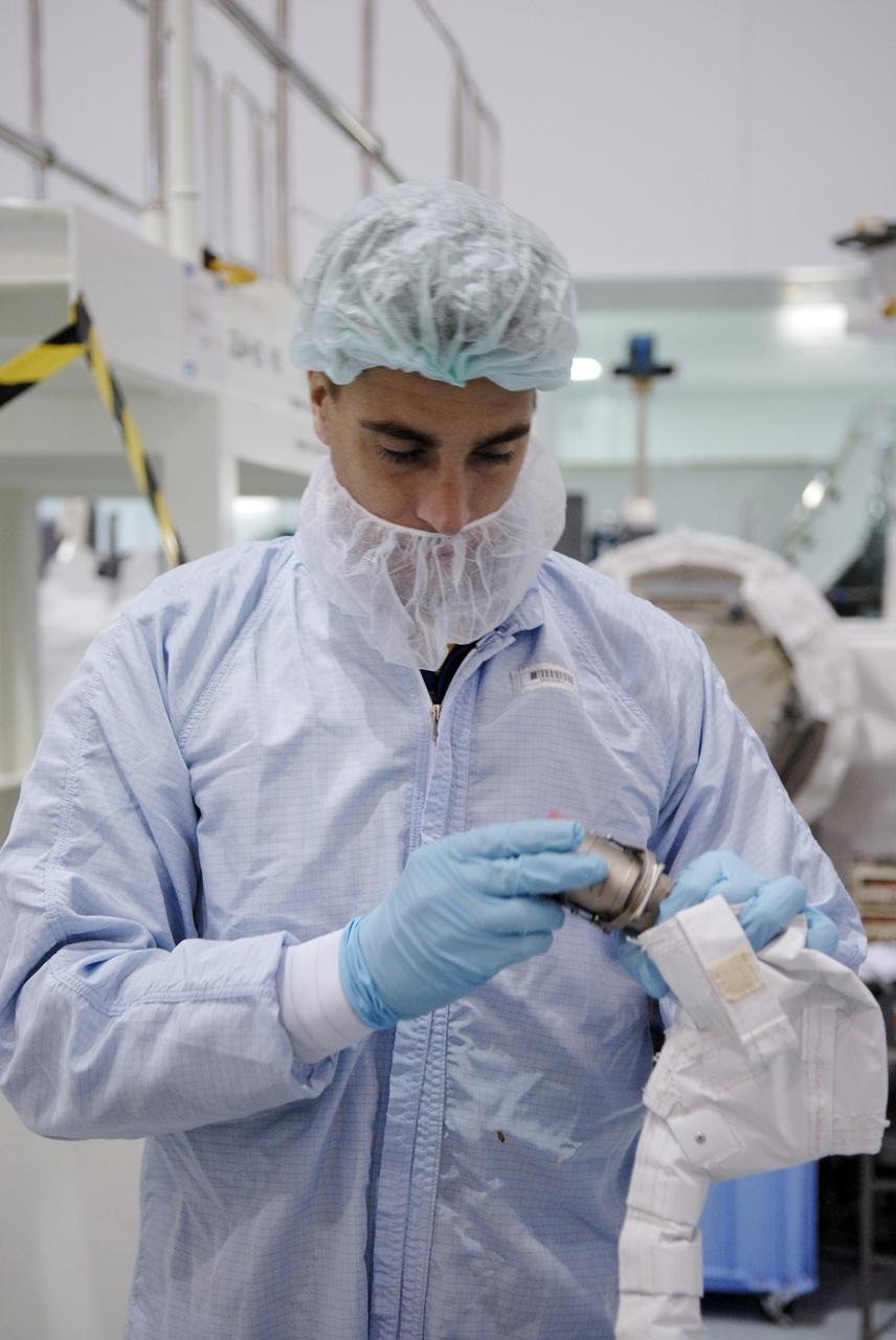 CAPE CANAVERAL, Fla. – In the Space Station Processing Facility at NASA's Kennedy Space Center in Florida, STS-127 Mission Specialist Christopher Cassidy looks at a piece of equipment to be used on the mission. Other crew members are Commander Mark Polansky, Pilot Doug Hurley and Mission Specialists Tom Marshburn, Dave Wolf, Julie Payette and Tim Kopra. The mission payload includes the Japanese Experiment Module, or JEM, Extended Facility and the Inter-orbit Communication System Extended Facility, or ICS-EF. Equipment familiarization is part of a Crew Equipment Interface Test. The payload will be launched to the International Space Station aboard the space shuttle Endeavour on the STS-127 mission, targeted for launch on May 15, 2009. Photo credit: NASA/Kim Shiflett