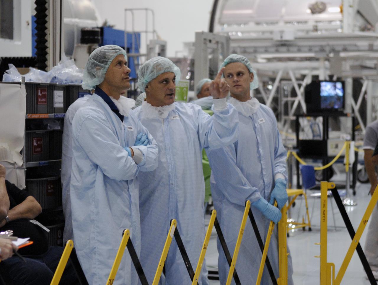 CAPE CANAVERAL, Fla. – In the Space Station Processing Facility at NASA's Kennedy Space Center in Florida, STS-127 mission crew members look over hardware for the mission. From left are Mission Specialists Tom Marshburn, Dave Wolf and Pilot Doug Hurley. Remaining crew members are Commander Mark Polansky and Mission Specialists Christopher Cassidy, Julie Payette and Tim Kopra. The mission payload includes the Japanese Experiment Module, or JEM, Extended Facility and the Inter-orbit Communication System Extended Facility, or ICS-EF. Equipment familiarization is part of a Crew Equipment Interface Test. The payload will be launched to the International Space Station aboard the space shuttle Endeavour on the STS-127 mission, targeted for launch on May 15, 2009. Photo credit: NASA/Kim Shiflett