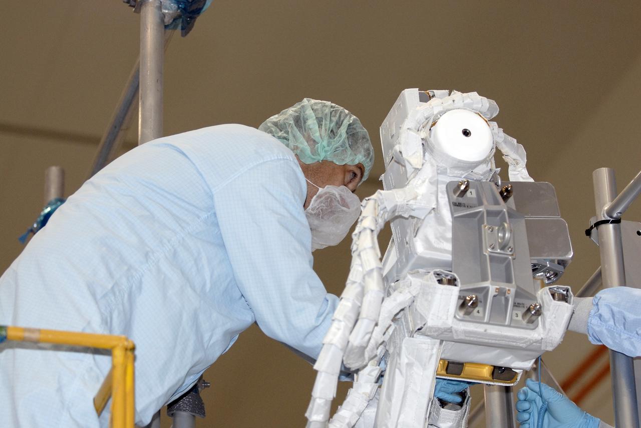 CAPE CANAVERAL, Fla. – In the Space Station Processing Facility at NASA's Kennedy Space Center in Florida, STS-127 mission crew members inspect the installation of the Japanese Aerospace Exploration Agency's Visual Equipments, or VE, to its final spot since they will have to do this as part of an EVA on the mission. The VE has to be installed to the final position on orbit because it is outside of the payload bay envelope. The mission payload includes the Japanese Experiment Module, or JEM, Extended Facility and the Inter-orbit Communication System Extended Facility, or ICS-EF. Equipment familiarization is part of a Crew Equipment Interface Test. The payload will be launched to the International Space Station aboard the space shuttle Endeavour on the STS-127 mission, targeted for launch on May 15, 2009. Photo credit: NASA/Kim Shiflett