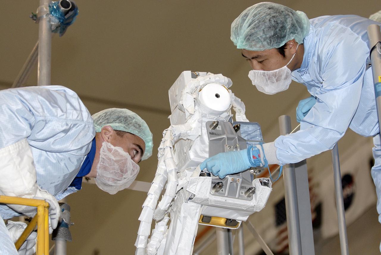 CAPE CANAVERAL, Fla. – In the Space Station Processing Facility at NASA's Kennedy Space Center in Florida, STS-127 mission crew members inspect the installation of the Japanese Aerospace Exploration Agency's Visual Equipments, or VE, to its final spot since they will have to do this as part of an EVA on the mission. The VE has to be installed to the final position on orbit because it is outside of the payload bay envelope. The mission payload includes the Japanese Experiment Module, or JEM, Extended Facility and the Inter-orbit Communication System Extended Facility, or ICS-EF. Equipment familiarization is part of a Crew Equipment Interface Test. The payload will be launched to the International Space Station aboard the space shuttle Endeavour on the STS-127 mission, targeted for launch on May 15, 2009. Photo credit: NASA/Kim Shiflett