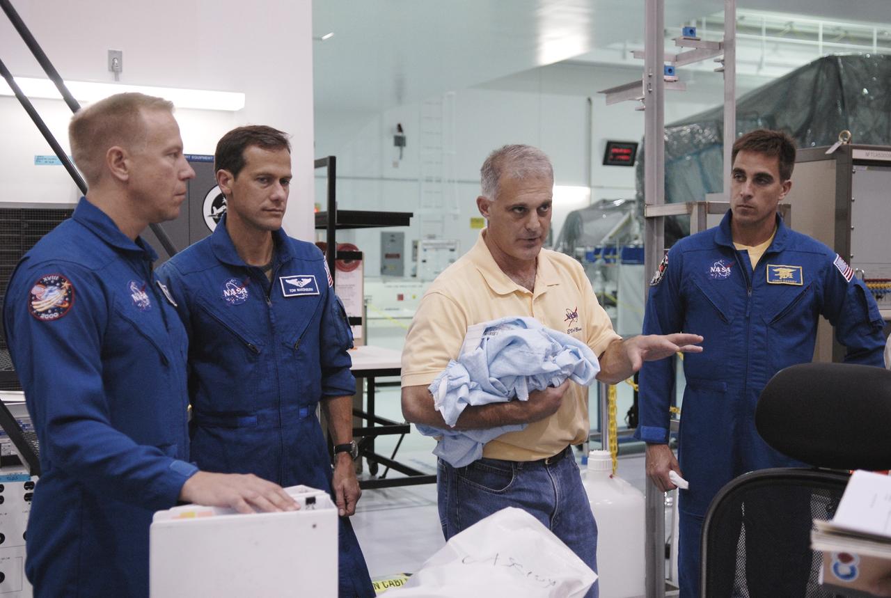 CAPE CANAVERAL, Fla. – In the Space Station Processing Facility at NASA's Kennedy Space Center in Florida, STS-127 crew members discuss some of the equipment for the mission. From left are Mission Specialists Tim Kopra, Tom Marshburn, Dave Wolf and Christopher Cassidy. Other crew members are Commander Mark Polansky, Pilot Doug Hurley and Mission Specialist Julie Payette. The mission payload includes the Japanese Experiment Module, or JEM, Extended Facility and the Inter-orbit Communication System Extended Facility, or ICS-EF. Equipment familiarization is part of a Crew Equipment Interface Test. The payload will be launched to the International Space Station aboard the space shuttle Endeavour on the STS-127 mission, targeted for launch on May 15, 2009. Photo credit: NASA/Kim Shiflett