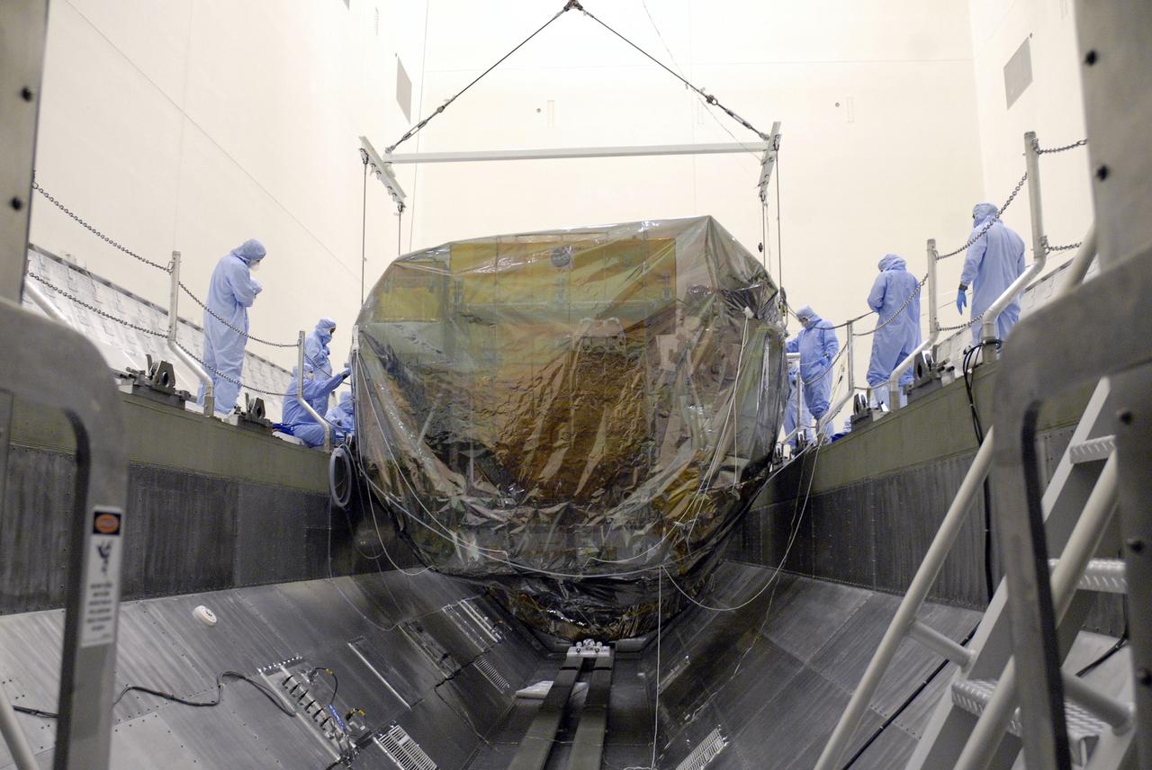CAPE CANAVERAL, Fla. - In the Payload Hazardous Servicing Facility, or PHSF, at NASA's Kennedy Space Center in Florida, the Orbital Replacement Unit Carrier, or ORUC, is removed from the payload canister which transported the Hubble Space Telescope equipment back to the clean room from Launch Pad 39A.  The payload for Hubble servicing mission 4 comprises four carriers holding various equipment for the mission. In the PHSF, the carriers will be stored until a new target launch date in 2009 can be set for Atlantis’ STS-125 mission. Atlantis’ October target launch date was delayed after a device on board Hubble, used in the storage and transmission of science data to Earth, shut down on Sept. 27. Replacing the broken device will be added to Atlantis’ servicing mission to the telescope.  Photo credit: NASA/Jim Grossmann