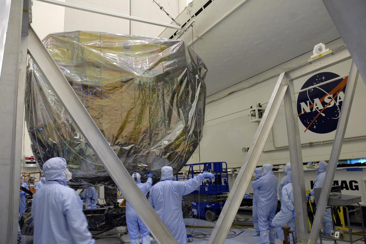 CAPE CANAVERAL, Fla. - In the Payload Hazardous Servicing Facility, or PHSF, at NASA's Kennedy Space Center in Florida, workers position the Orbital Replacement Unit Carrier, or ORUC, onto a stand after it was returned back to the clean room from Launch Pad 39A. The payload for Hubble servicing mission 4 comprises four carriers holding various equipment for the mission. In the PHSF, the carriers will be stored until a new target launch date in 2009 can be set for Atlantis’ STS-125 mission. Atlantis’ October target launch date was delayed after a device on board Hubble, used in the storage and transmission of science data to Earth, shut down on Sept. 27. Replacing the broken device will be added to Atlantis’ servicing mission to the telescope.  Photo credit: NASA/Jim Grossmann