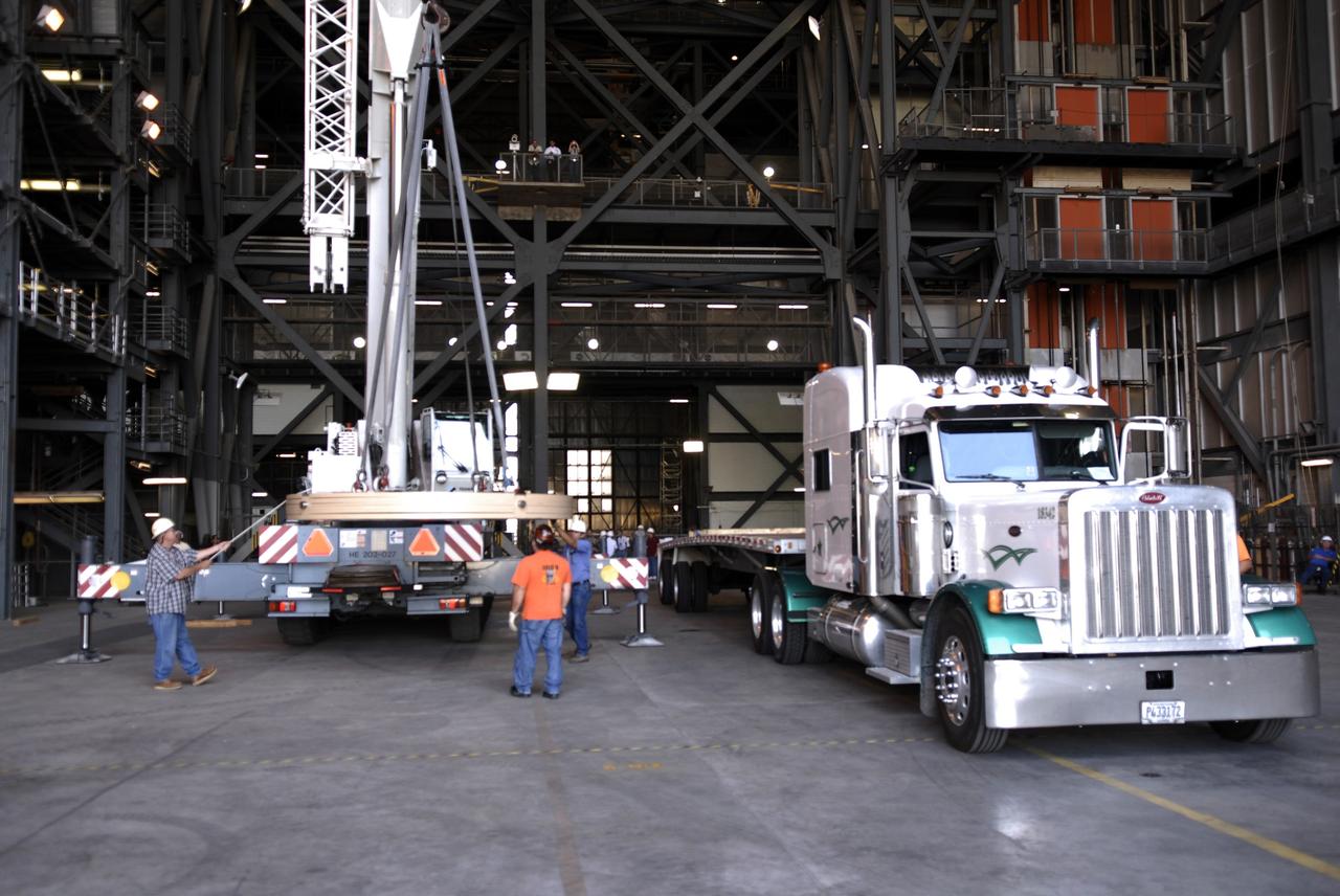 CAPE CANAVERAL, Fla. - The Ares IX upper stage segments’ ballast assemblies are offloaded from one of five trucks which delivered them to the Vehicle Assembly Building at NASA’s Kennedy Space Center, part of the preparations for the test of the Ares IX rocket. These ballast assemblies will be installed in the upper stage 1 and 7 segments and will mimic the mass of the fuel.  Their total weight is approximately 160,000 pounds.  The test launch of the Ares IX in 2009 will be the first designed to determine the flight-worthiness of the Ares I rocket.  Ares I is an in-line, two-stage rocket that will transport the Orion crew exploration vehicle to low-Earth orbit. The Ares I first stage will be a five-segment solid rocket booster based on the four-segment design used for the space shuttle. Ares I’s fifth booster segment allows the launch vehicle to lift more weight and reach a higher altitude before the first stage separates from the upper stage, which ignites in midflight to propel the Orion spacecraft to Earth orbit.  Photo credit: NASA/Kim Shiflett