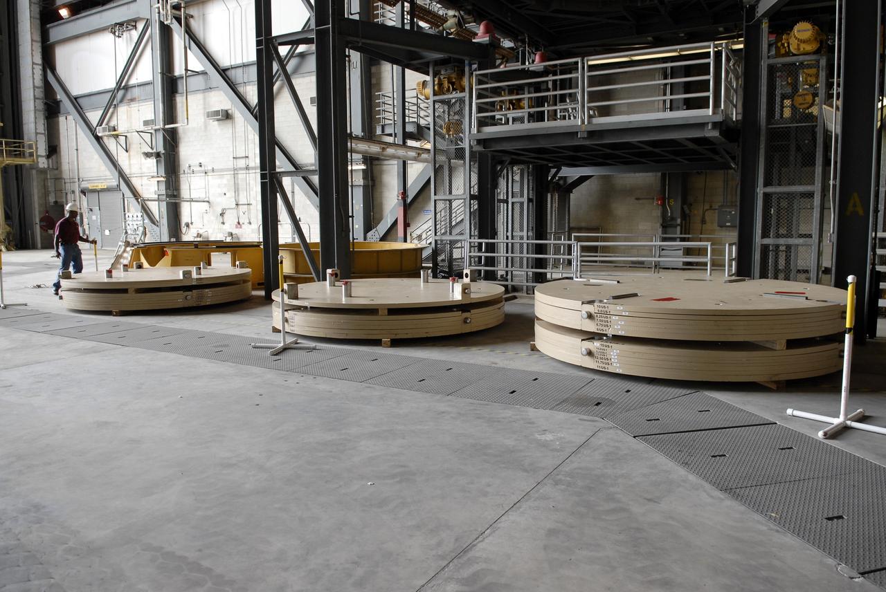 CAPE CANAVERAL, Fla. - Ares IX upper stage segments’ ballast assemblies are positioned along the floor of high bay 4 in the Vehicle Assembly Building at NASA’s Kennedy Space Center, part of the preparations for the test of the Ares IX rocket. These ballast assemblies will be installed in the upper stage 1 and 7 segments and will mimic the mass of the fuel.  Their total weight is approximately 160,000 pounds.  The test launch of the Ares IX in 2009 will be the first designed to determine the flight-worthiness of the Ares I rocket.  Ares I is an in-line, two-stage rocket that will transport the Orion crew exploration vehicle to low-Earth orbit. The Ares I first stage will be a five-segment solid rocket booster based on the four-segment design used for the space shuttle. Ares I’s fifth booster segment allows the launch vehicle to lift more weight and reach a higher altitude before the first stage separates from the upper stage, which ignites in midflight to propel the Orion spacecraft to Earth orbit.  Photo credit: NASA/Kim Shiflett