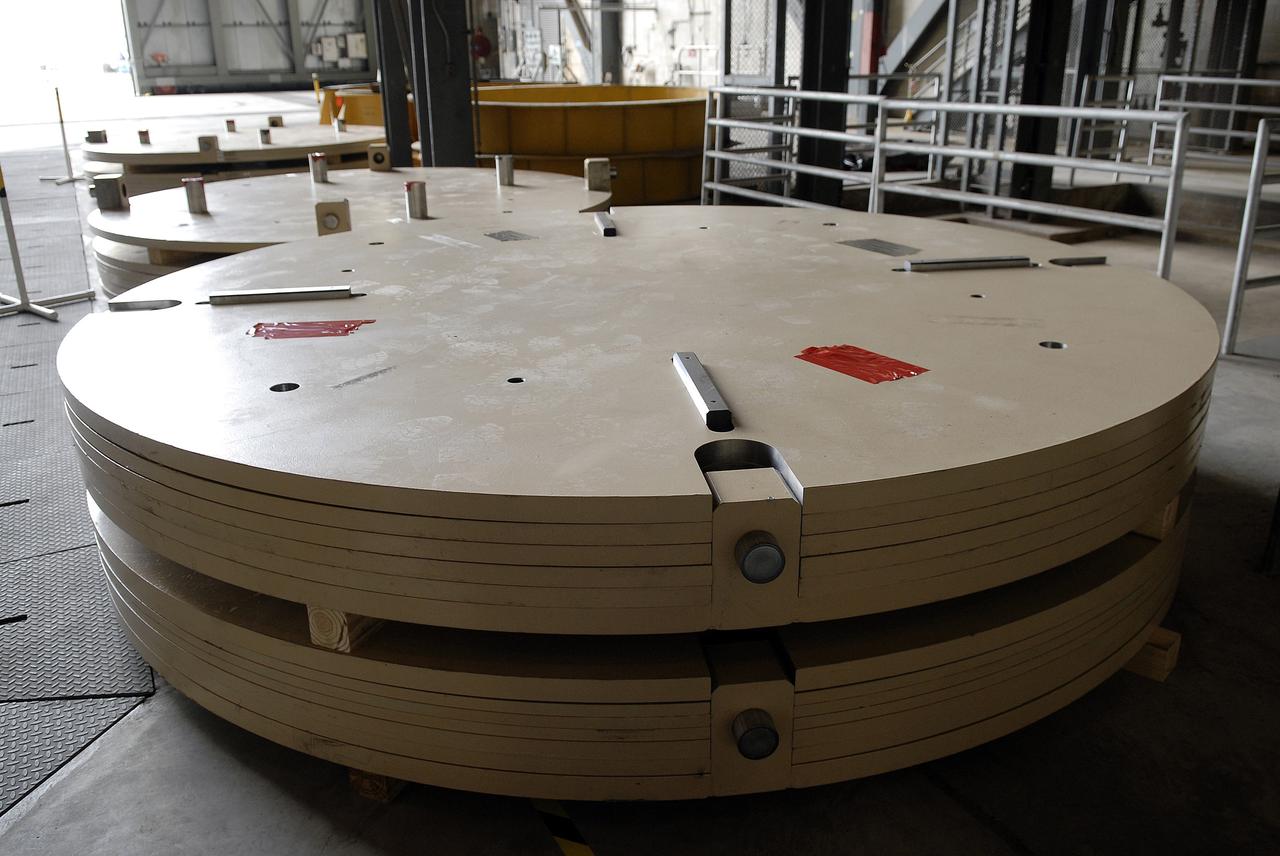 CAPE CANAVERAL, Fla. - The Ares IX upper stage segments’ ballast assemblies have arrived at NASA’s Kennedy Space Center and are positioned along the floor of high bay 4 in the Vehicle Assembly Building, part of the preparations for the test of the Ares IX rocket. These ballast assemblies will be installed in the upper stage 1 and 7 segments and will mimic the mass of the fuel.  Their total weight is approximately 160,000 pounds.  The test launch of the Ares IX in 2009 will be the first designed to determine the flight-worthiness of the Ares I rocket.  Ares I is an in-line, two-stage rocket that will transport the Orion crew exploration vehicle to low-Earth orbit. The Ares I first stage will be a five-segment solid rocket booster based on the four-segment design used for the space shuttle. Ares I’s fifth booster segment allows the launch vehicle to lift more weight and reach a higher altitude before the first stage separates from the upper stage, which ignites in midflight to propel the Orion spacecraft to Earth orbit.  Photo credit: NASA/Kim Shiflett