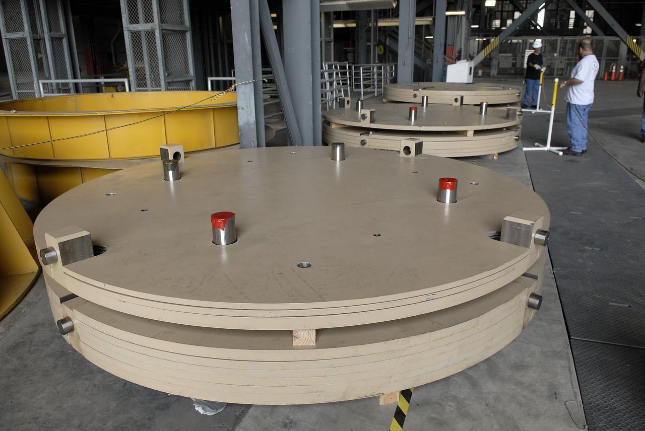 CAPE CANAVERAL, Fla. - The Ares IX upper stage segments’ ballast assemblies have arrived at NASA’s Kennedy Space Center and are positioned along the floor of high bay 4 in the Vehicle Assembly Building, part of the preparations for the test of the Ares IX rocket. These ballast assemblies will be installed in the upper stage 1 and 7 segments and will mimic the mass of the fuel.  Their total weight is approximately 160,000 pounds.  The test launch of the Ares IX in 2009 will be the first designed to determine the flight-worthiness of the Ares I rocket.  Ares I is an in-line, two-stage rocket that will transport the Orion crew exploration vehicle to low-Earth orbit. The Ares I first stage will be a five-segment solid rocket booster based on the four-segment design used for the space shuttle. Ares I’s fifth booster segment allows the launch vehicle to lift more weight and reach a higher altitude before the first stage separates from the upper stage, which ignites in midflight to propel the Orion spacecraft to Earth orbit.  Photo credit: NASA/Kim Shiflett