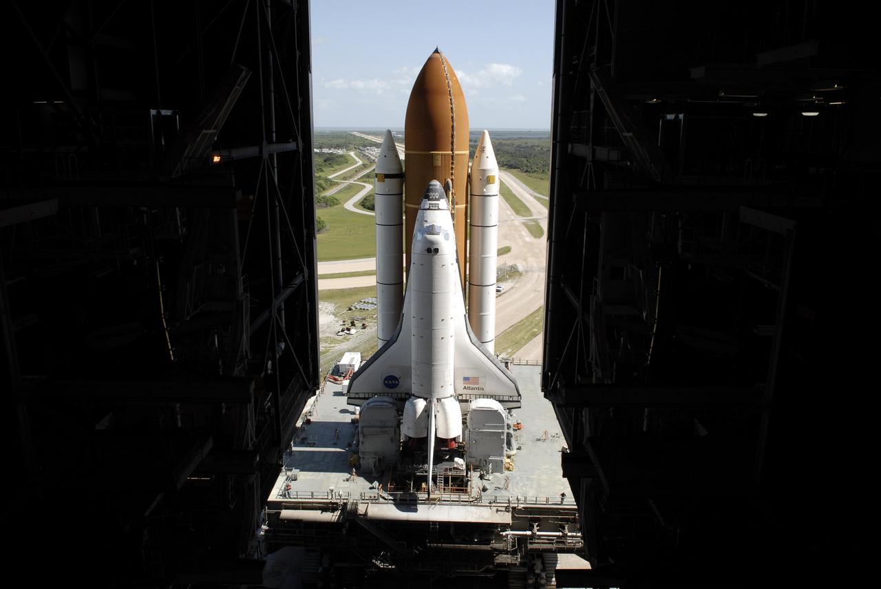 CAPE CANAVERAL, Fla. - Space Space shuttle Atlantis rolls through the open doors of the Vehicle Assembly Building's high bay 3 at NASA's Kennedy Space Center in Florida after rolling back from Launch Pad 39A. In the VAB, Atlantis will await launch on its STS-125 mission to repair NASA's Hubble Space Telescope.  First motion of Atlantis off the pad was at 6:48 a.m. EDT. The journey was expected to take about six hours.  Atlantis' targeted launch on Oct. 14 was delayed when a system that transfers science data from the orbiting observatory to Earth malfunctioned on Sept. 27. The new target launch date is under review.  Photo credit: NASA/Kim Shiflett