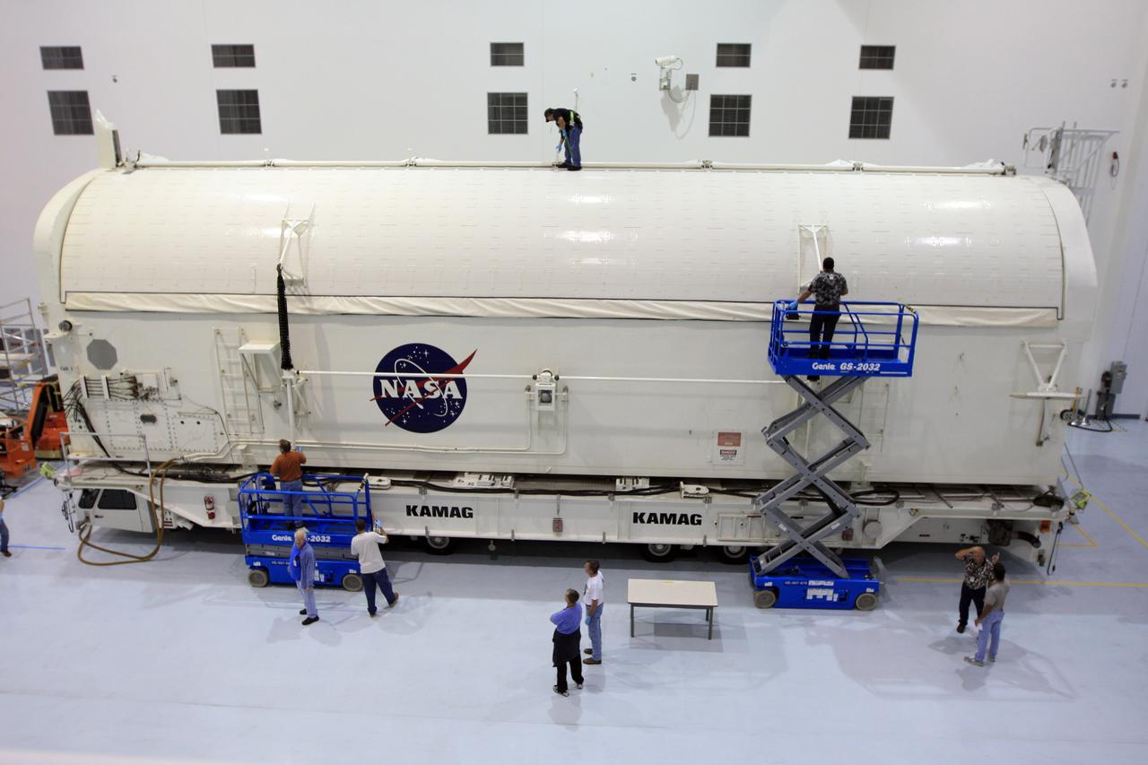 CAPE CANAVERAL, Fla. -   In the Space Station Processing Facility at NASA's Kennedy Space Center in Florida, workers secure the closed doors of the payload canister containing the payload for space shuttle Endeavour's STS-126 mission.  Inside the canister are the Multi-Purpose Logistics Module Leonardo and the Lightweight Multi-Purpose Experiment Support Structure Carrier.  The canister next will be transported to the Canister Rotation Facility to raise it to vertical and then will be taken to Launch Pad 39A. At the pad, the payload canister will release its cargo into the Payload Changeout Room.  Later, the payload will be installed in Endeavour's payload bay.  Endeavour is targeted for launch on Nov. 14.  Photo credit: NASA/Troy Cryder