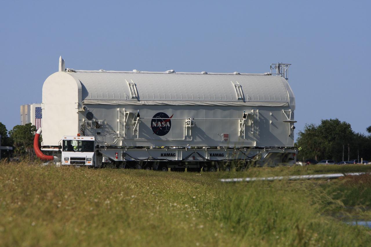 CAPE CANAVERAL, Fla. - The payload canister containing the payload for space shuttle Endeavour's STS-126 mission is transported to Launch Pad 39A at NASA's Kennedy Space Center in Florida. Behind the canister, at left, is the Vehicle Assembly Building. At the pad, the payload canister will release its cargo into the Payload Changeout Room. Later, the payload will be installed in Endeavour's payload bay. Endeavour is targeted for launch on Nov. 14. Photo credit: NASA/Troy Cryder
