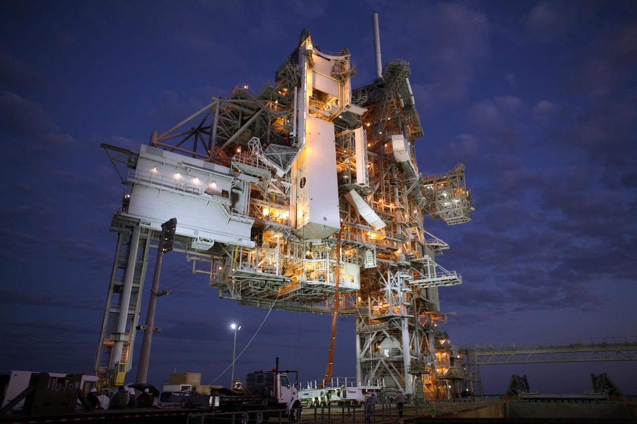 CAPE CANAVERAL, Fla. - On Launch Pad 39A at NASA's Kennedy Space Center in Florida, the payload canister with space shuttle Endeavour's STS-126 mission payload inside is lifted to the Payload Changeout Room, or PCR, above. Inside the canister are the Multi-Purpose Logistics Module Leonardo and the Lightweight Multi-Purpose Experiment Support Structure Carrier. The red umbilical lines attached preserve the environmentally controlled interior. The payload canister will release its cargo into the PCR. Later, the payload will be installed in Endeavour's payload bay. Endeavour is targeted for launch on Nov. 14. Photo credit: NASA/Dimitri Gerondidakis