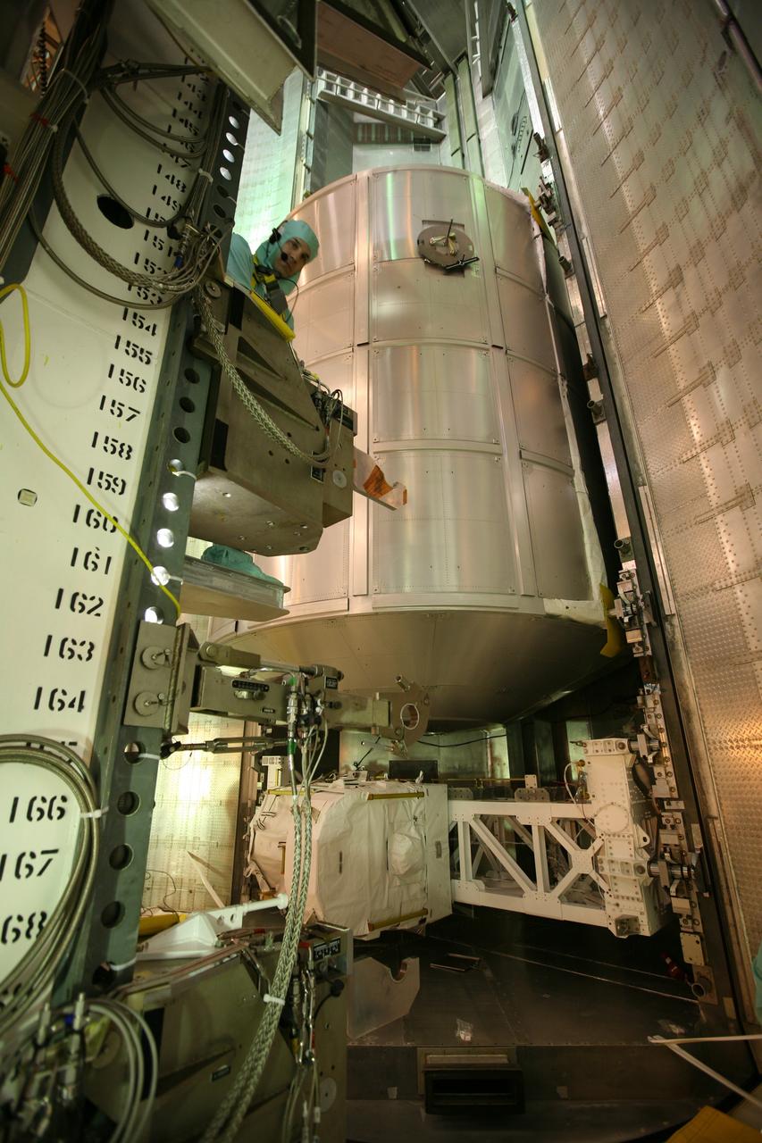 CAPE CANAVERAL, Fla. -    On Launch Pad 39A at NASA's Kennedy Space Center in Florida, workers use the payload ground-handling mechanism in the Payload Changeout Room, or PCR, to aid the transfer of the Multi-Purpose Logistics Module Leonardo (center) and the Lightweight Multi-Purpose Experiment Support Structure Carrier (bottom) from the payload canister into the PCR.   Later, the payload will be installed in Endeavour's payload bay.  Endeavour is targeted for launch on Nov. 14.  Photo credit: NASA/Dimitri Gerondidakis