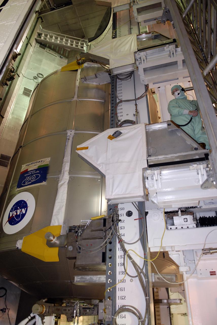 CAPE CANAVERAL, Fla. - In the Payload Changeout Room, or PCR, on Launch Pad 39A at NASA's Kennedy Space Center in Florida, workers use the payload ground-handling mechanism to transfer space shuttle Endeavour's STS-126 mission payload from the payload canister. At left is seen the Multi-Purpose Logistics Module Leonardo. The payload later will be installed in Endeavour's payload bay. Endeavour is targeted for launch on Nov. 14. Photo credit: NASA/Kim Shiflett