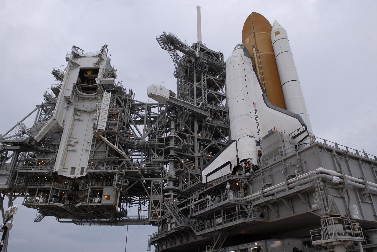CAPE CANAVERAL, Fla. - At NASA's Kennedy Space Center in Florida, space shuttle Endeavour begins rolling off Launch Pad 39B for the 3.4-mile rollaround to Launch Pad 39A. First motion was at 8:28 a.m. EDT. To the left is the open rotating service structure with the Payload Changeout Room and the fixed service structure with the 80-foot-tall lightning mast on top. Endeavour is targeted to launch Nov. 14 on the STS-126 mission. On this 27th mission to the International Space Station, Endeavour will carry the Lightweight Multi-Purpose Experiment Support Structure Carrier and the Multi-Purpose Logistics Module Leonardo that will hold supplies and equipment, including additional crew quarters, additional exercise equipment, spare hardware and equipment for the regenerative life support system. Photo credit: NASA/Kim Shiflett
