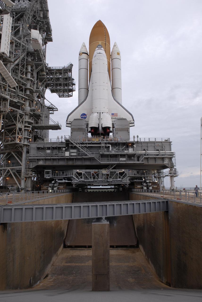 CAPE CANAVERAL, Fla. - At NASA's Kennedy Space Center in Florida, space shuttle Endeavour atop the mobile launcher platform and crawler-transporter span the flame trench as they begin rolling off Launch Pad 39B for the 3.4-mile rollaround to Launch Pad 39A. First motion was at 8:28 a.m. EDT. Endeavour is targeted to launch Nov. 14 on the STS-126 mission. On this 27th mission to the International Space Station, Endeavour will carry the Lightweight Multi-Purpose Experiment Support Structure Carrier and the Multi-Purpose Logistics Module Leonardo that will hold supplies and equipment, including additional crew quarters, additional exercise equipment, spare hardware and equipment for the regenerative life support system. Photo credit: NASA/Kim Shiflett