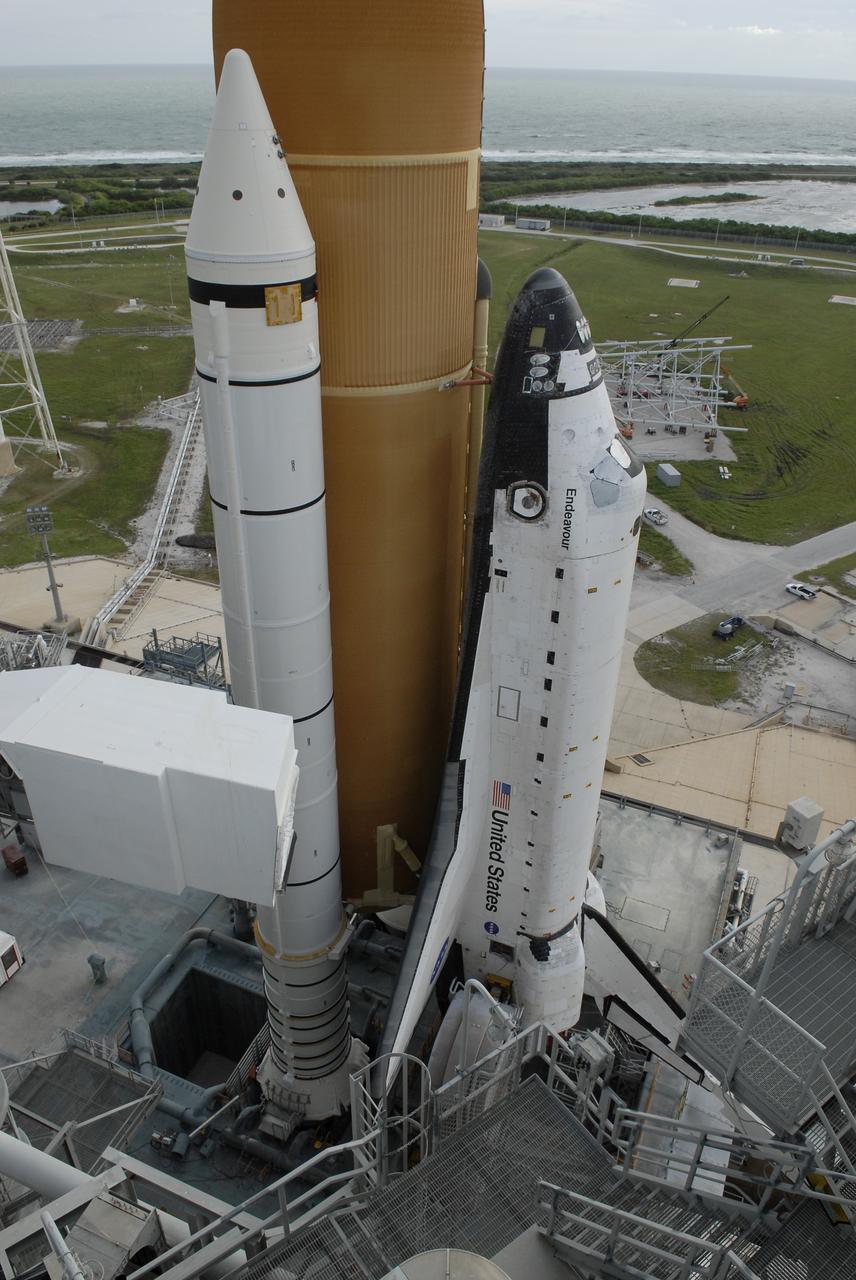 CAPE CANAVERAL, Fla. - At NASA's Kennedy Space Center in Florida, space shuttle Endeavour atop the mobile launcher platform is seen as it begins rolling off Launch Pad 39B for the 3.4-mile rollaround to Launch Pad 39A. First motion was at 8:28 a.m. EDT. The white object at left is the White Room at the end of the orbiter access arm on the fixed service structure. Endeavour is targeted to launch Nov. 14 on the STS-126 mission. On this 27th mission to the International Space Station, Endeavour will carry the Lightweight Multi-Purpose Experiment Support Structure Carrier and the Multi-Purpose Logistics Module Leonardo that will hold supplies and equipment, including additional crew quarters, additional exercise equipment, spare hardware and equipment for the regenerative life support system. Photo credit: NASA/Kim Shiflett