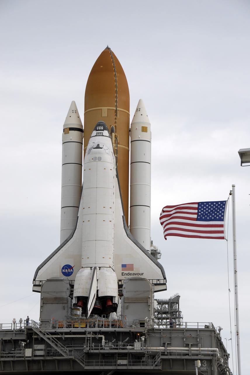 CAPE CANAVERAL, Fla. - At NASA's Kennedy Space Center in Florida, space shuttle Endeavour is rolling off Launch Pad 39B for the 3.4-mile rollaround to Launch Pad 39A. The waving flag indicates the crawler-transporter is nearing the pad gate. First motion was at 8:28 a.m. EDT. Endeavour is targeted to launch Nov. 14 on the STS-126 mission. On this 27th mission to the International Space Station, Endeavour will carry the Lightweight Multi-Purpose Experiment Support Structure Carrier and the Multi-Purpose Logistics Module Leonardo that will hold supplies and equipment, including additional crew quarters, additional exercise equipment, spare hardware and equipment for the regenerative life support system. Photo credit: NASA/Kim Shiflett