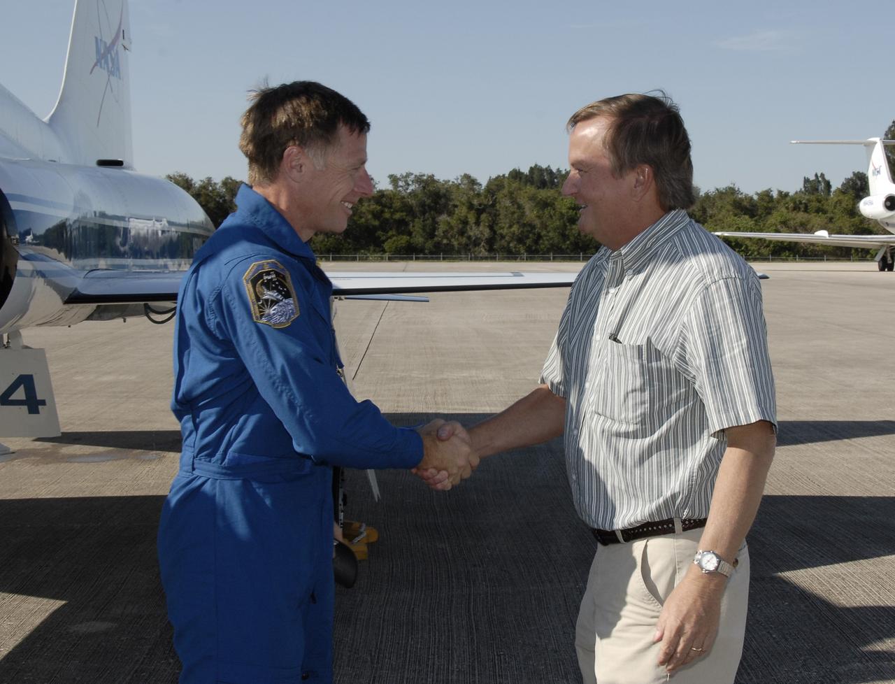 CAPE CANAVERAL, Fla. - STS-126 Commander Chris Ferguson, left, is greeted by Shuttle Launch Director Mike Linebach following his arrival at the Shuttle Landing Facility at NASA’s Kennedy Space Center in Florida for Terminal Countdown Demonstration Test, or TCDT, activities. During TCDT, Endeavour's astronauts and launch teams will participate in a simulated countdown, practice emergency exit procedures at the launch pad and continue to familiarize themselves with the mission payload and hardware. On this 27th mission to the International Space Station, Endeavour will carry the Lightweight Multi-Purpose Experiment Support Structure Carrier and the Multi-Purpose Logistics Module Leonardo that will hold supplies and equipment, including additional crew quarters, additional exercise equipment, spare hardware and equipment for the regenerative life support system. Endeavour is targeted to launch at 7:55 p.m. EST on Nov. 14. Photo credit: NASA/Kim Shiflett
