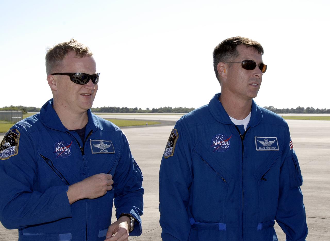 CAPE CANAVERAL, Fla. - STS-126 Pilot Eric Boe, left, and Mission Specialist Shane Kimbrough arrive at the Shuttle Landing Facility at NASA’s Kennedy Space Center in Florida for Terminal Countdown Demonstration Test, or TCDT, activities. During TCDT, Endeavour's astronauts and launch teams will participate in a simulated countdown, practice emergency exit procedures at the launch pad and continue to familiarize themselves with the mission payload and hardware. On this 27th mission to the International Space Station, Endeavour will carry the Lightweight Multi-Purpose Experiment Support Structure Carrier and the Multi-Purpose Logistics Module Leonardo that will hold supplies and equipment, including additional crew quarters, additional exercise equipment, spare hardware and equipment for the regenerative life support system. Endeavour is targeted to launch at 7:55 p.m. EST on Nov. 14. Photo credit: NASA/Kim Shiflett