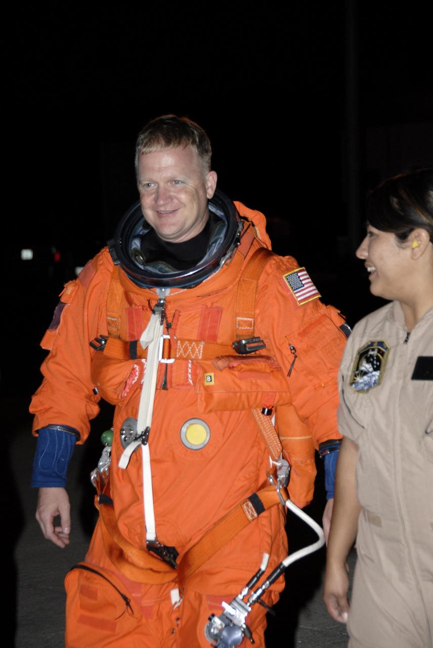 CAPE CANAVERAL, Fla. - At NASA's Kennedy Space Center in Florida, STS-126 Pilot Eric Boe heads across the parking apron of the Shuttle Landing Facility to the Shuttle Training Aircraft, or STA. He will practice shuttle landings in the STA, a Grumman American Aviation-built Gulf Stream II jet that was modified to simulate a shuttle’s cockpit, motion and visual cues, and handling qualities. In flight, the aircraft duplicates the shuttle’s atmospheric descent trajectory from approximately 35,000 feet to landing. The practice is part of the Terminal Countdown Demonstration Test, which includes equipment familiarization, emergency exit procedures and a simulated launch countdown. On the STS-126 mission, space shuttle Endeavour's crew will deliver equipment and supplies to the International Space Station in preparation for expansion from a three- to six-person resident crew aboard the complex. The mission also will include four spacewalks to service the station’s Solar Alpha Rotary Joints. Endeavour is targeted to launch Nov. 14. Photo credit: NASA/Kim Shiflett
