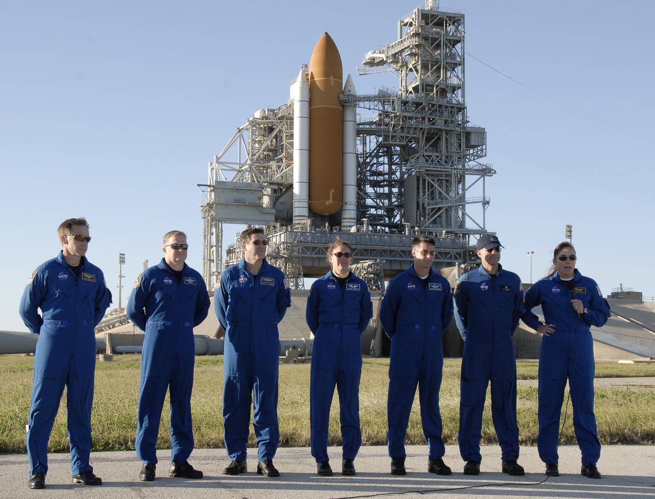 CAPE CANAVERAL, Fla. -   On Launch Pad 39A at NASA's Kennedy Space Center in Florida, STS-126 Mission Specialist Heidemarie Stefanyshyn-Piper (far right) answers a question from the media.  The other crew members with her are (from left) Commander Chris Ferguson, Pilot Eric Boe and Mission Specialists Steve Bowen, Sandra Magnus, Shane Kimbrough and Donald Pettit. Behind them is space shuttle Endeavour. The crew is at Kennedy to take part in the Terminal Countdown Demonstration Test, which includes equipment familiarization, emergency exit procedures and a simulated launch countdown.  On the STS-126 mission, space shuttle Endeavour's crew will deliver equipment and supplies to the International Space Station in preparation for expansion from a three- to six-person resident crew aboard the complex. The mission also will include four spacewalks to service the station’s Solar Alpha Rotary Joints. Endeavour is targeted to launch Nov. 14.  Photo credit: NASA/Kim Shiflett