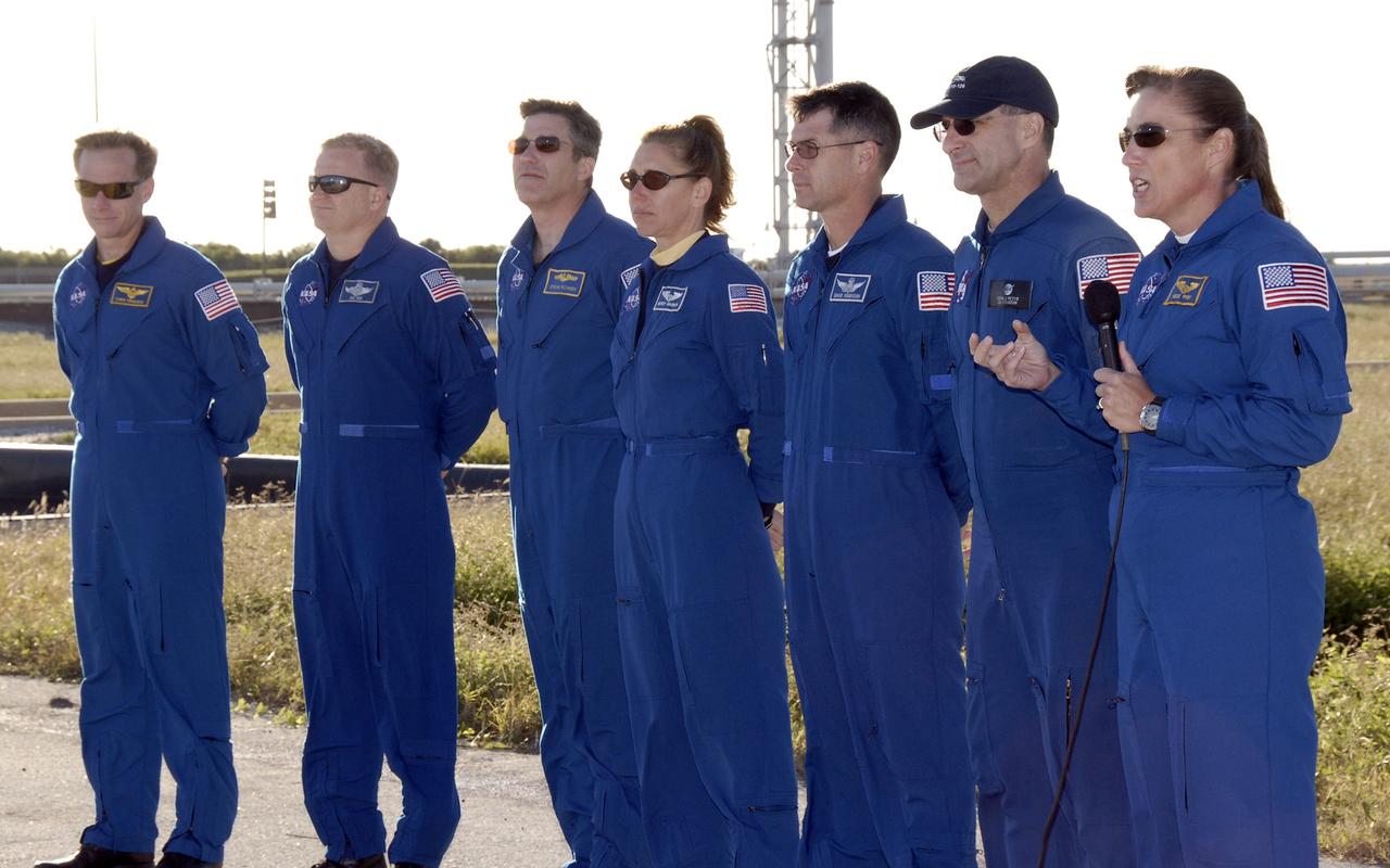 CAPE CANAVERAL, Fla. -    On Launch Pad 39A at NASA's Kennedy Space Center in Florida, STS-126 Mission Specialist Heidemarie Stefanyshyn-Piper (far right) answers a question from the media.  The other crew members with her are (from left) Commander Chris Ferguson, Pilot Eric Boe and Mission Specialists Steve Bowen, Sandra Magnus, Shane Kimbrough and Donald Pettit. The crew is at Kennedy to take part in the Terminal Countdown Demonstration Test, which includes equipment familiarization, emergency exit procedures and a simulated launch countdown.  On the STS-126 mission, space shuttle Endeavour's crew will deliver equipment and supplies to the International Space Station in preparation for expansion from a three- to six-person resident crew aboard the complex. The mission also will include four spacewalks to service the station’s Solar Alpha Rotary Joints. Endeavour is targeted to launch Nov. 14.  Photo credit: NASA/Kim Shiflett