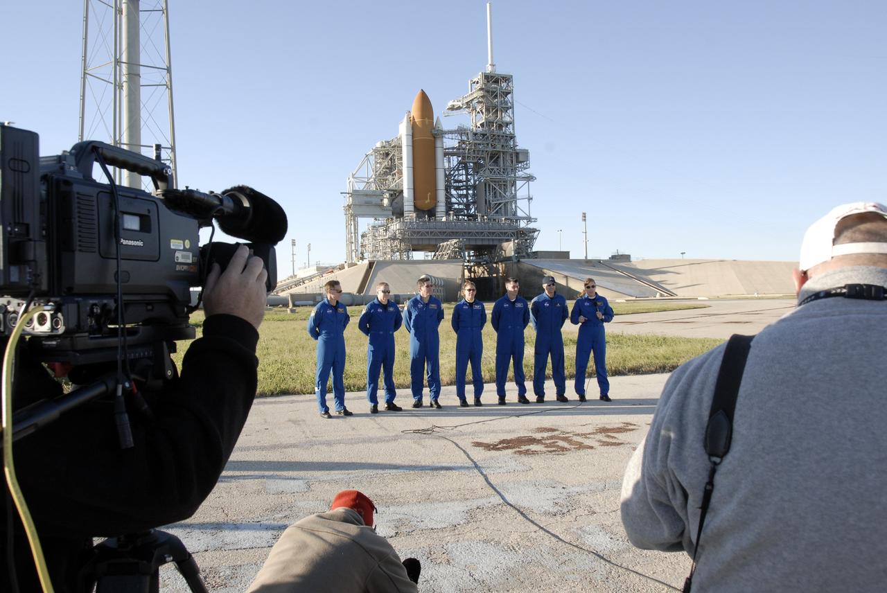 CAPE CANAVERAL, Fla. -  With space shuttle Endeavour as the backdrop, the STS-126 crew members are gathered on Launch Pad 39A at NASA's Kennedy Space Center in Florida to answer questions from the media (seen in the foreground).   From left are Commander Chris Ferguson, Pilot Eric Boe and Mission Specialists Steve Bowen, Sandra Magnus, Shane Kimbrough, Donald Pettit and Heidemarie Stefanyshyn-Piper. The crew is at Kennedy to take part in the Terminal Countdown Demonstration Test, which includes equipment familiarization, emergency exit procedures and a simulated launch countdown.  On the STS-126 mission, space shuttle Endeavour's crew will deliver equipment and supplies to the International Space Station in preparation for expansion from a three- to six-person resident crew aboard the complex. The mission also will include four spacewalks to service the station’s Solar Alpha Rotary Joints. Endeavour is targeted to launch Nov. 14.  Photo credit: NASA/Kim Shiflett