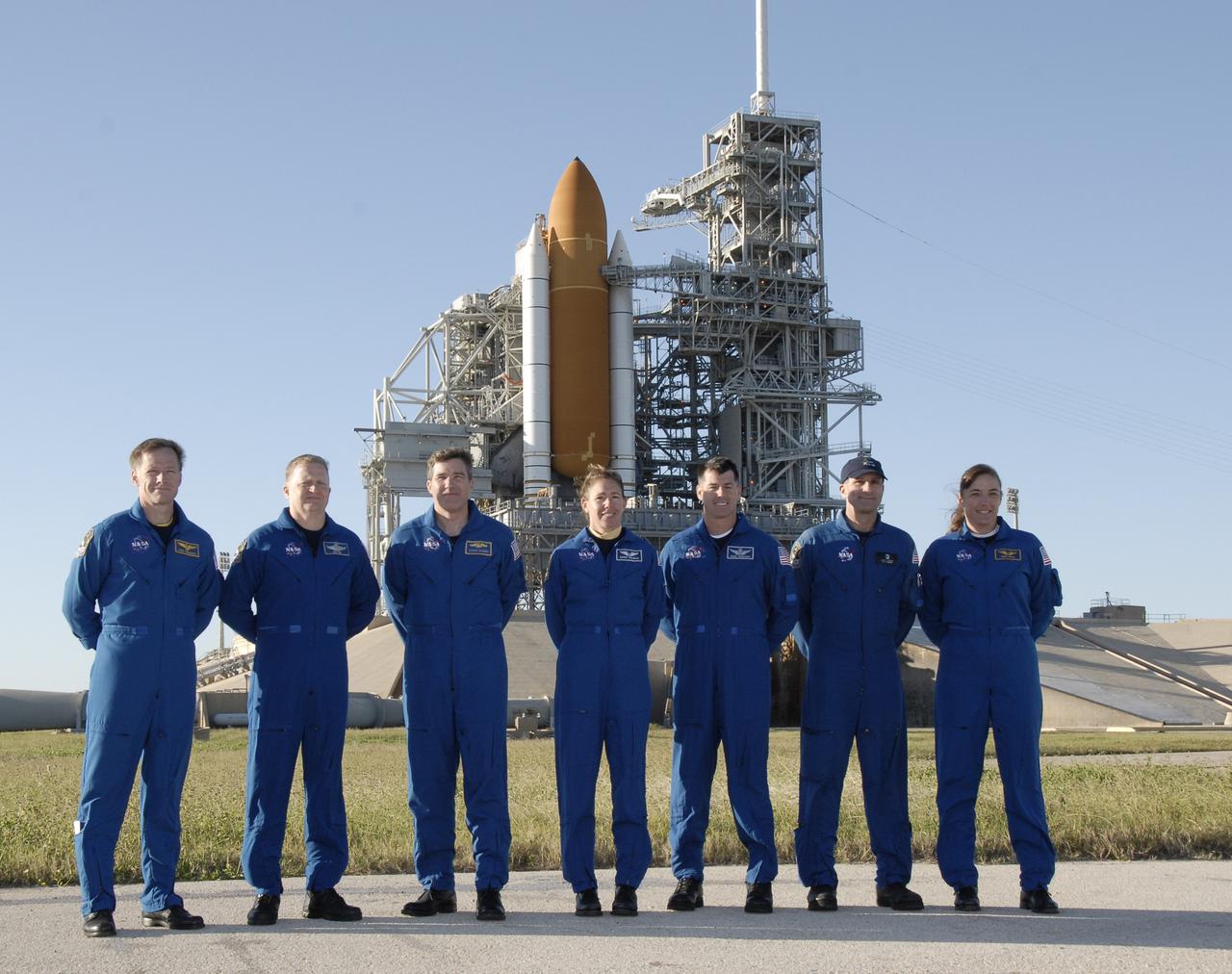 CAPE CANAVERAL, Fla. -  With space shuttle Endeavour as the backdrop on Launch Pad 39 at NASA's Kennedy Space Center in Florida, the STS-126 crew members pose for a final photo after answering questions from the media.  From left are Commander Chris Ferguson, Pilot Eric Boe and Mission Specialists Steve Bowen, Sandra Magnus, Shane Kimbrough, Donald Pettit and Heidemarie Stefanyshyn-Piper. The crew is at Kennedy to take part in the Terminal Countdown Demonstration Test, which includes equipment familiarization, emergency exit procedures and a simulated launch countdown.  On the STS-126 mission, space shuttle Endeavour's crew will deliver equipment and supplies to the International Space Station in preparation for expansion from a three- to six-person resident crew aboard the complex. The mission also will include four spacewalks to service the station’s Solar Alpha Rotary Joints. Endeavour is targeted to launch Nov. 14.  Photo credit: NASA/Kim Shiflett