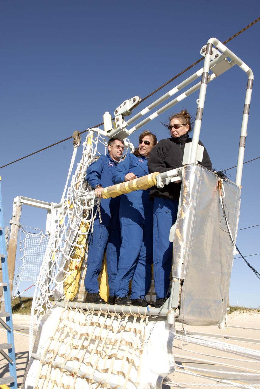 CAPE CANAVERAL, Fla. –  During emergency escape training on Launch Pad 39A at NASA's Kennedy Space Center in Florida, STS-126 Mission Specialists Shane Kimbrough, Heidemarie Stefanyshyn-Piper and Sandra Magnus test the slidewire basket.  The crew is at Kennedy to take part in the Terminal Countdown Demonstration Test, which includes equipment familiarization, emergency exit training and a simulated launch countdown.  On the STS-126 mission, space shuttle Endeavour's crew will deliver equipment and supplies to the International Space Station in preparation for expansion from a three- to six-person resident crew aboard the complex. The mission also will include four spacewalks to service the station’s Solar Alpha Rotary Joints. Endeavour is targeted to launch Nov. 14. Photo credit: NASA/Kim Shiflett