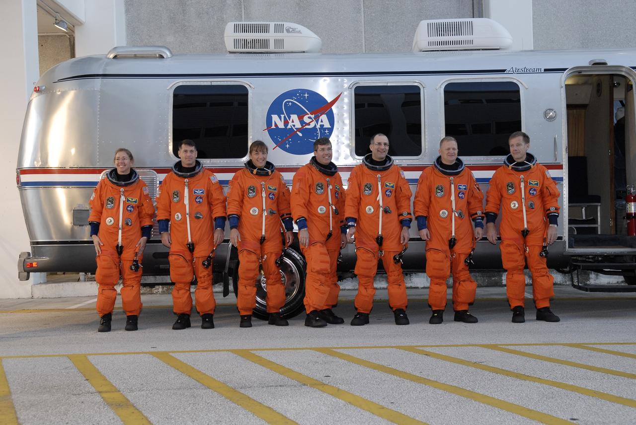CAPE CANAVERAL, Fla. – Dressed in their launch-and-entry suits, the STS-126 crew members pause by the Astrovan after walking out of the Operations and Checkout Building at NASA's Kennedy Space Center in Florida. They will head to Launch Pad 39A for a simulated countdown in space shuttle Endeavour. From left are Mission Specialists Sandra Magnus, Shane Kimbrough, Heidemarie Stefanyshyn-Piper, Steven Bowen and Donald Pettit, Pilot Eric Boe and Commander Chris Ferguson. The crew is at Kennedy to take part in the Terminal Countdown Demonstration Test, which includes equipment familiarization, emergency exit training and the simulated countdown. On the STS-126 mission, space shuttle Endeavour's crew will deliver equipment and supplies to the International Space Station in preparation for expansion from a three- to six-person resident crew aboard the complex. The mission also will include four spacewalks to service the station’s Solar Alpha Rotary Joints. Endeavour is targeted to launch Nov. 14. Photo credit: NASA/Kim Shiflett