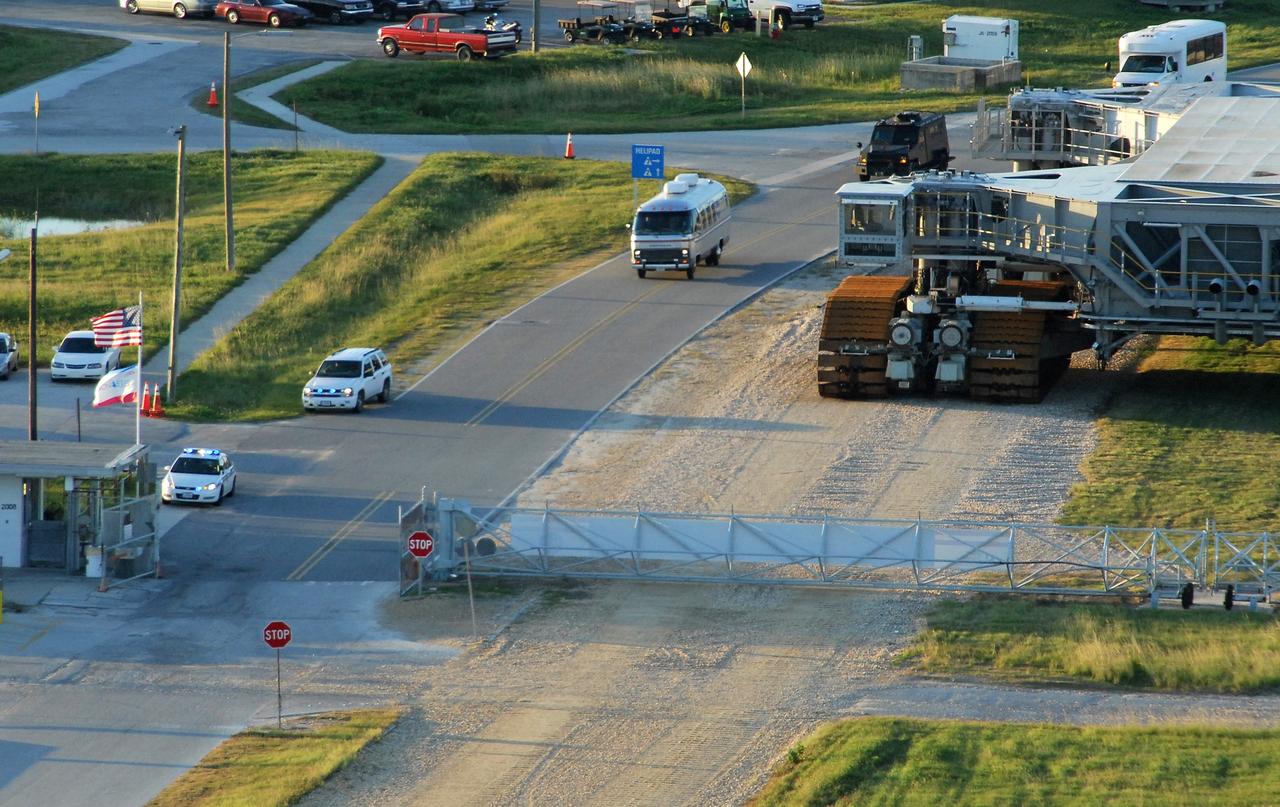 CAPE CANAVERAL, Fla. – Led by security, the Astrovan (center) with the STS-126 crew members aboard travels the road to Launch Pad 39A at NASA's Kennedy Space Center in Florida. At right is one of the crawler transporters on the crawlerway. The crew will take part in a simulated launch countdown at the pad. The White Room is at the end of the orbiter access arm and provides entry into the shuttle. The crew is at Kennedy to take part in the Terminal Countdown Demonstration Test, which includes equipment familiarization, emergency exit training and the simulated countdown. On the STS-126 mission, space shuttle Endeavour's crew will deliver equipment and supplies to the International Space Station in preparation for expansion from a three- to six-person resident crew aboard the complex. The mission also will include four spacewalks to service the station’s Solar Alpha Rotary Joints. Endeavour is targeted to launch Nov. 14. Photo credit: NASA/Troy Cryder