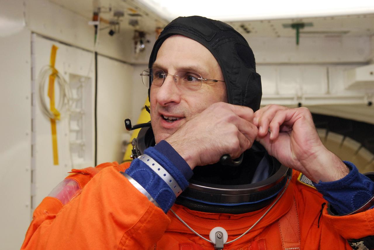 CAPE CANAVERAL, Fla. – In the White Room on Launch Pad 39A at NASA's Kennedy Space Center in Florida, STS-126 Mission Specialist Donald Pettit adjusts his headset. He will enter space shuttle Endeavour to take part in a simulated launch countdown with the other crew members. The crew is at Kennedy to take part in the Terminal Countdown Demonstration Test, which includes equipment familiarization, emergency exit training and the simulated countdown. On the STS-126 mission, space shuttle Endeavour's crew will deliver equipment and supplies to the International Space Station in preparation for expansion from a three- to six-person resident crew aboard the complex. The mission also will include four spacewalks to service the station’s Solar Alpha Rotary Joints. Endeavour is targeted to launch Nov. 14. Photo credit: NASA/Troy Cryder