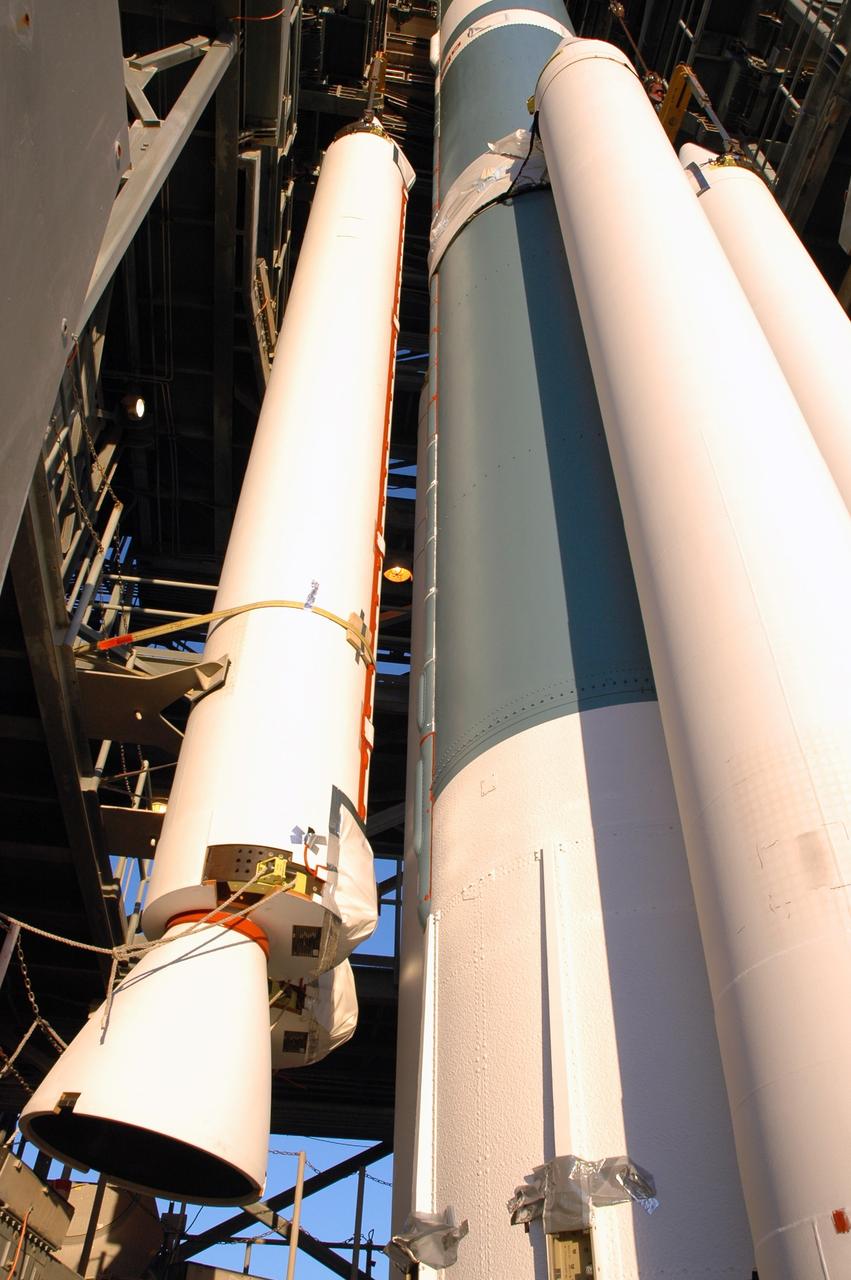 CAPE CANAVERAL, Fla. – On Launch Pad 17-B at Cape Canaveral Air Force Station in Florida, an air-lit strap-on solid rocket booster is lifted up for mating onto the Delta 2 launch vehicle that will carry the Kepler spacecraft into orbit. The Kepler mission is specifically designed to survey our region of the Milky Way galaxy to discover hundreds of Earth-size and smaller planets in or near the habitable zone and determine how many of the billions of stars in our galaxy have such planets. Results from this mission will allow us to place our solar system within the continuum of planetary systems in the Galaxy. NASA's planet-hunting Kepler mission is scheduled to launch no earlier than March 5, 2009. Photo credit: NASA/Jim Grossmann