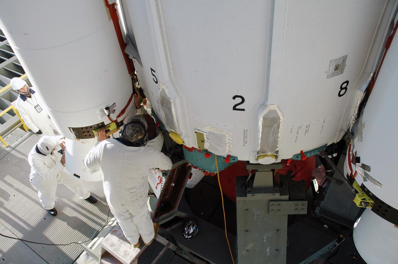 CAPE CANAVERAL, Fla. – On Launch Pad 17-B at Cape Canaveral Air Force Station in Florida, workers mate an air-lit strap-on solid rocket booster onto the Delta 2 launch vehicle that will carry the Kepler spacecraft into orbit. The Kepler mission is specifically designed to survey our region of the Milky Way galaxy to discover hundreds of Earth-size and smaller planets in or near the habitable zone and determine how many of the billions of stars in our galaxy have such planets. Results from this mission will allow us to place our solar system within the continuum of planetary systems in the Galaxy. NASA's planet-hunting Kepler mission is scheduled to launch no earlier than March 5, 2009. Photo credit: NASA/Jim Grossmann