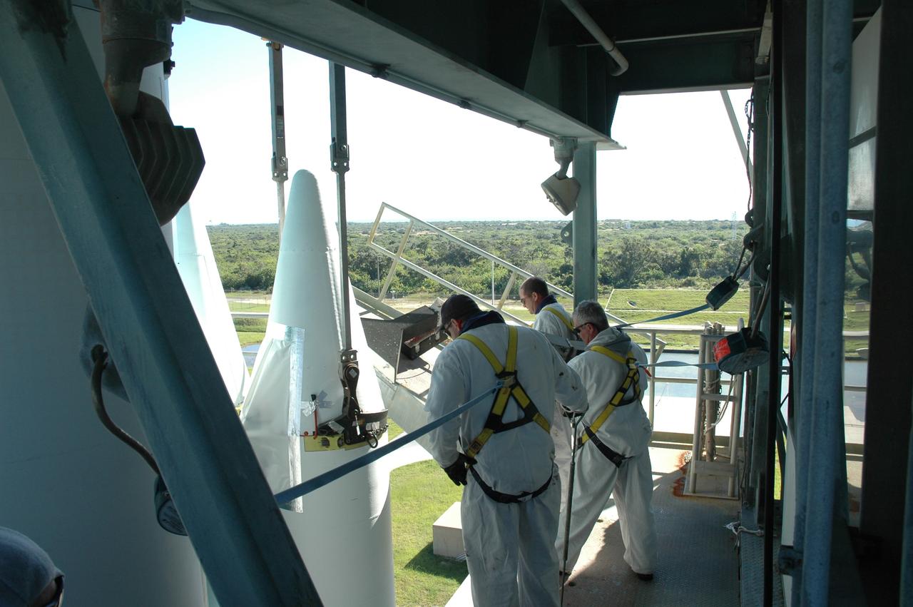 CAPE CANAVERAL, Fla. – On Launch Pad 17-B at Cape Canaveral Air Force Station in Florida, workers on an upper level of the launch tower watch as a strap-on solid rocket booster is lifted into place to mate to the first stage of the Delta 2 launch vehicle that will carry the Kepler spacecraft into orbit. The Kepler mission is specifically designed to survey our region of the Milky Way galaxy to discover hundreds of Earth-size and smaller planets in or near the habitable zone and determine how many of the billions of stars in our galaxy have such planets. Results from this mission will allow us to place our solar system within the continuum of planetary systems in the Galaxy. NASA's planet-hunting Kepler mission is scheduled to launch no earlier than March 5, 2009. Photo credit: NASA/Jim Grossmann
