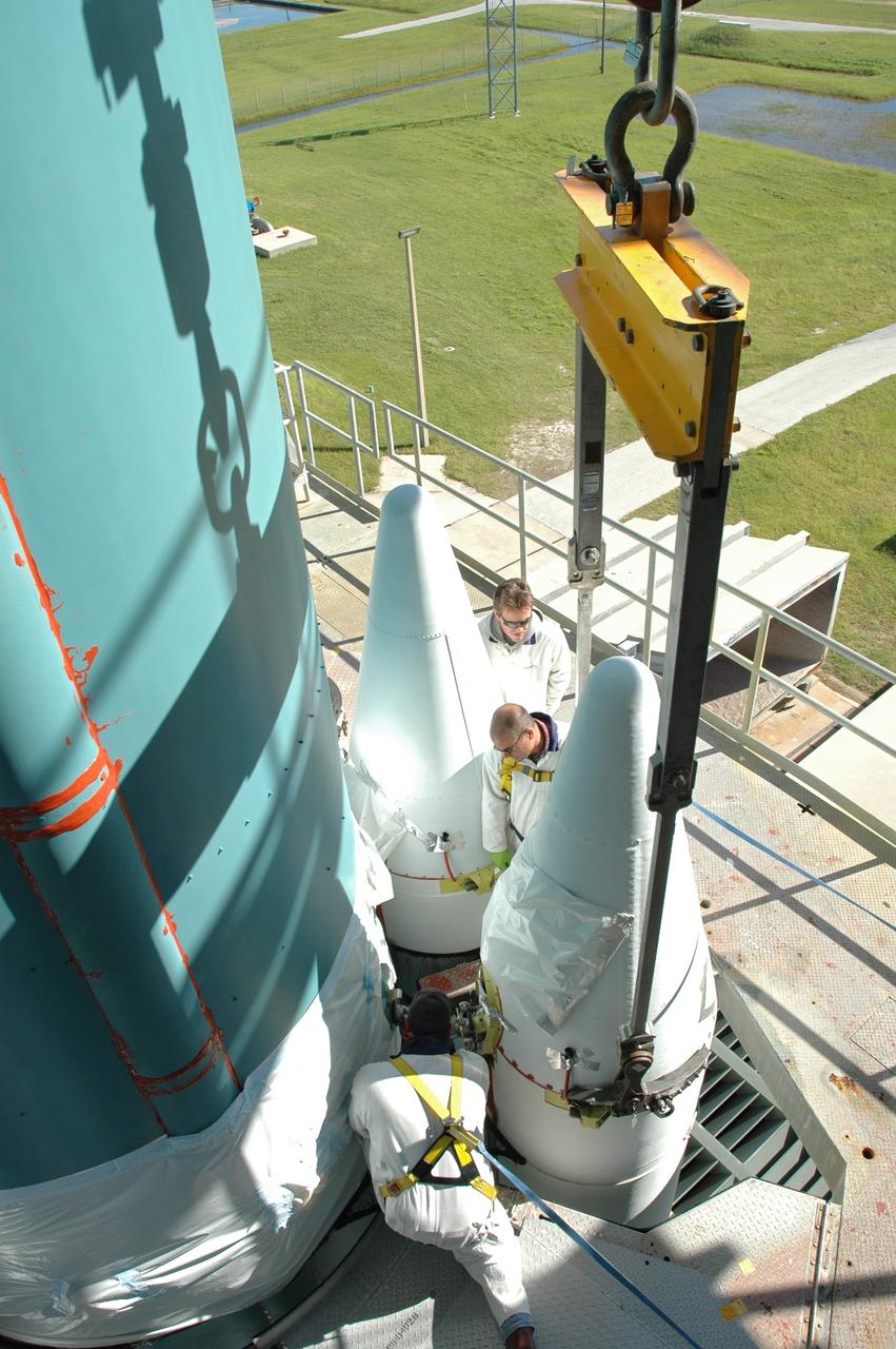CAPE CANAVERAL, Fla. – On Launch Pad 17-B at Cape Canaveral Air Force Station in Florida, workers make adjustments on one of the solid rocket boosters being mated to the first stage of the Delta 2 launch vehicle that will carry the Kepler spacecraft into orbit. The Kepler mission is specifically designed to survey our region of the Milky Way galaxy to discover hundreds of Earth-size and smaller planets in or near the habitable zone and determine how many of the billions of stars in our galaxy have such planets. Results from this mission will allow us to place our solar system within the continuum of planetary systems in the Galaxy. NASA's planet-hunting Kepler mission is scheduled to launch no earlier than March 5, 2009. Photo credit: NASA/Jim Grossmann