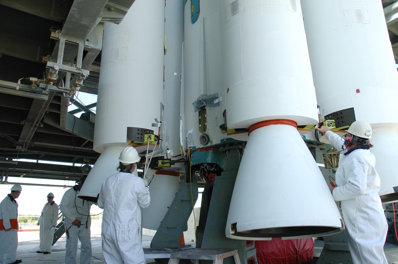 CAPE CANAVERAL, Fla. – On Launch Pad 17-B at Cape Canaveral Air Force Station in Florida, workers prepare to mate an air-lit strap-on solid rocket booster onto the Delta 2 launch vehicle that will carry the Kepler spacecraft into orbit. The Kepler mission is specifically designed to survey our region of the Milky Way galaxy to discover hundreds of Earth-size and smaller planets in or near the habitable zone and determine how many of the billions of stars in our galaxy have such planets. Results from this mission will allow us to place our solar system within the continuum of planetary systems in the Galaxy. NASA's planet-hunting Kepler mission is scheduled to launch no earlier than March 5, 2009. Photo credit: NASA/Jim Grossmann