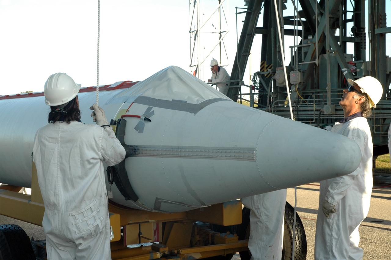 CAPE CANAVERAL, Fla. – On Launch Pad 17-B at Cape Canaveral Air Force Station in Florida, workers attach the crane that will lift one of the final solid rocket boosters for installation on the first stage of the Kepler's Delta 2 launch vehicle. The Kepler mission is specifically designed to survey our region of the Milky Way galaxy to discover hundreds of Earth-size and smaller planets in or near the habitable zone and determine how many of the billions of stars in our galaxy have such planets. Results from this mission will allow us to place our solar system within the continuum of planetary systems in the Galaxy. NASA's planet-hunting Kepler mission is scheduled to launch no earlier than March 5, 2009. Photo credit: NASA/Jim Grossmann