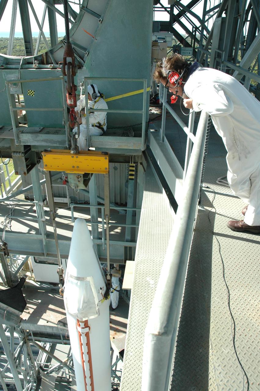 CAPE CANAVERAL, Fla. – On Launch Pad 17-B at Cape Canaveral Air Force Station in Florida, workers oversee the lifting of one of the solid rocket boosters into the mobile service tower for mating to the first stage of the Kepler's Delta 2 launch vehicle. The Kepler mission is specifically designed to survey our region of the Milky Way galaxy to discover hundreds of Earth-size and smaller planets in or near the habitable zone and determine how many of the billions of stars in our galaxy have such planets. Results from this mission will allow us to place our solar system within the continuum of planetary systems in the Galaxy. NASA's planet-hunting Kepler mission is scheduled to launch no earlier than March 5, 2009. Photo credit: NASA/Jim Grossmann