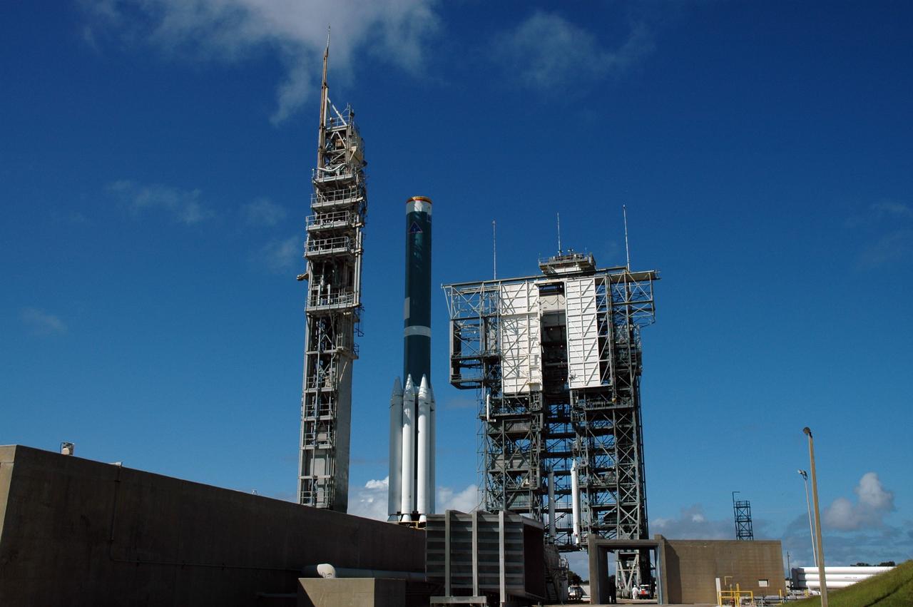CAPE CANAVERAL, Fla. – On Launch Pad 17-B at Cape Canaveral Air Force Station in Florida, the first stage of the Delta 2 launch vehicle for the Kepler spacecraft (center) waits for the mobile service tower at right and installation of the final three solid rocket boosters. The Kepler mission is specifically designed to survey our region of the Milky Way galaxy to discover hundreds of Earth-size and smaller planets in or near the habitable zone and determine how many of the billions of stars in our galaxy have such planets. Results from this mission will allow us to place our solar system within the continuum of planetary systems in the Galaxy. NASA's planet-hunting Kepler mission is scheduled to launch no earlier than March 5, 2009. Photo credit: NASA/Jim Grossmann