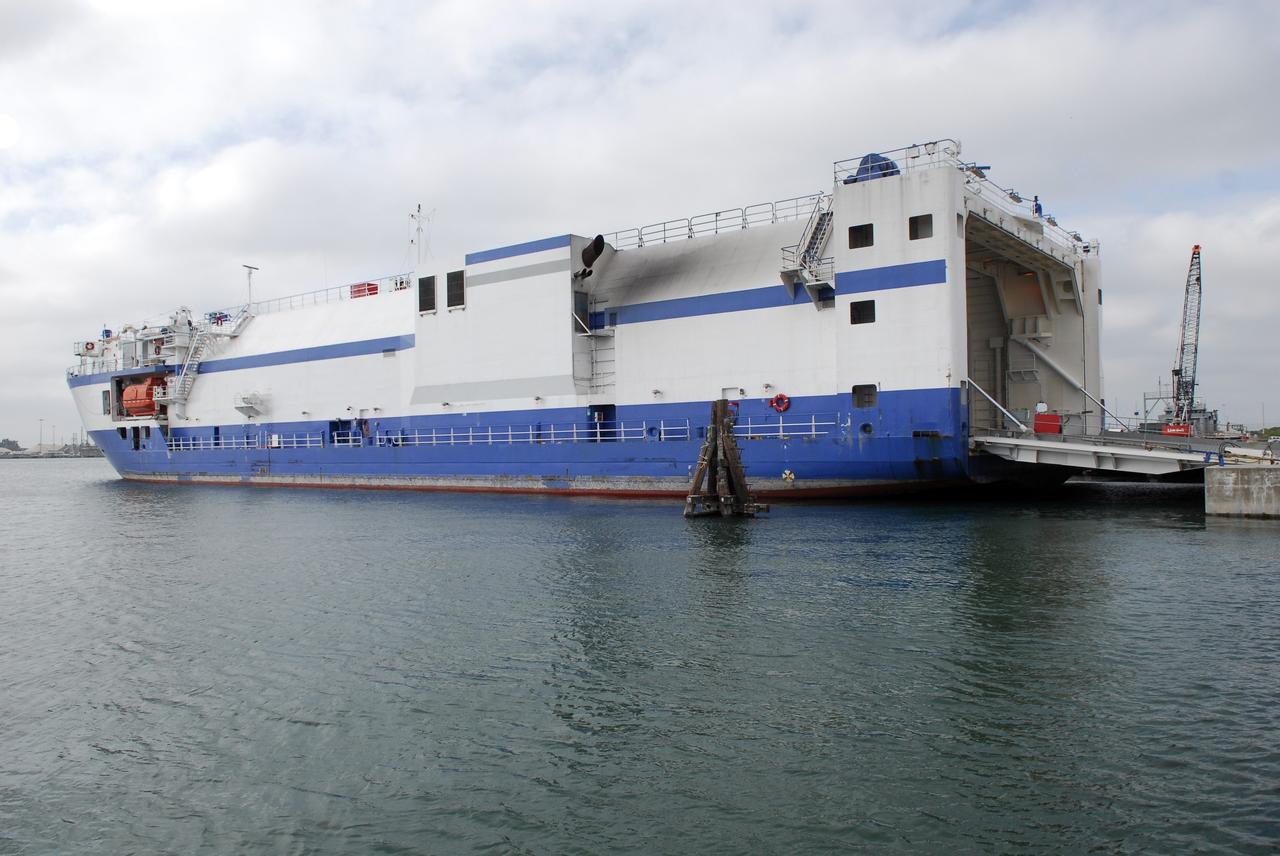 CAPE CANAVERAL, Fla. –  The Delta Mariner docks at Port Canaveral, Fla., with its cargo of the Ares I-X upper stage simulator segments. The upper stage simulator will be used in the test flight identified as Ares I-X in 2009.  The segments will simulate the mass and the outer mold line and will be more than 100 feet of the total vehicle height of 327 feet.  The simulator comprises 11 segments that are approximately 18 feet in diameter.  Most of the segments will be approximately 10 feet high, ranging in weight from 18,000 to 60,000 pounds, for a total of approximately 450,000 pounds.  Photo credit: NASA/Dimitri Gerondidakis