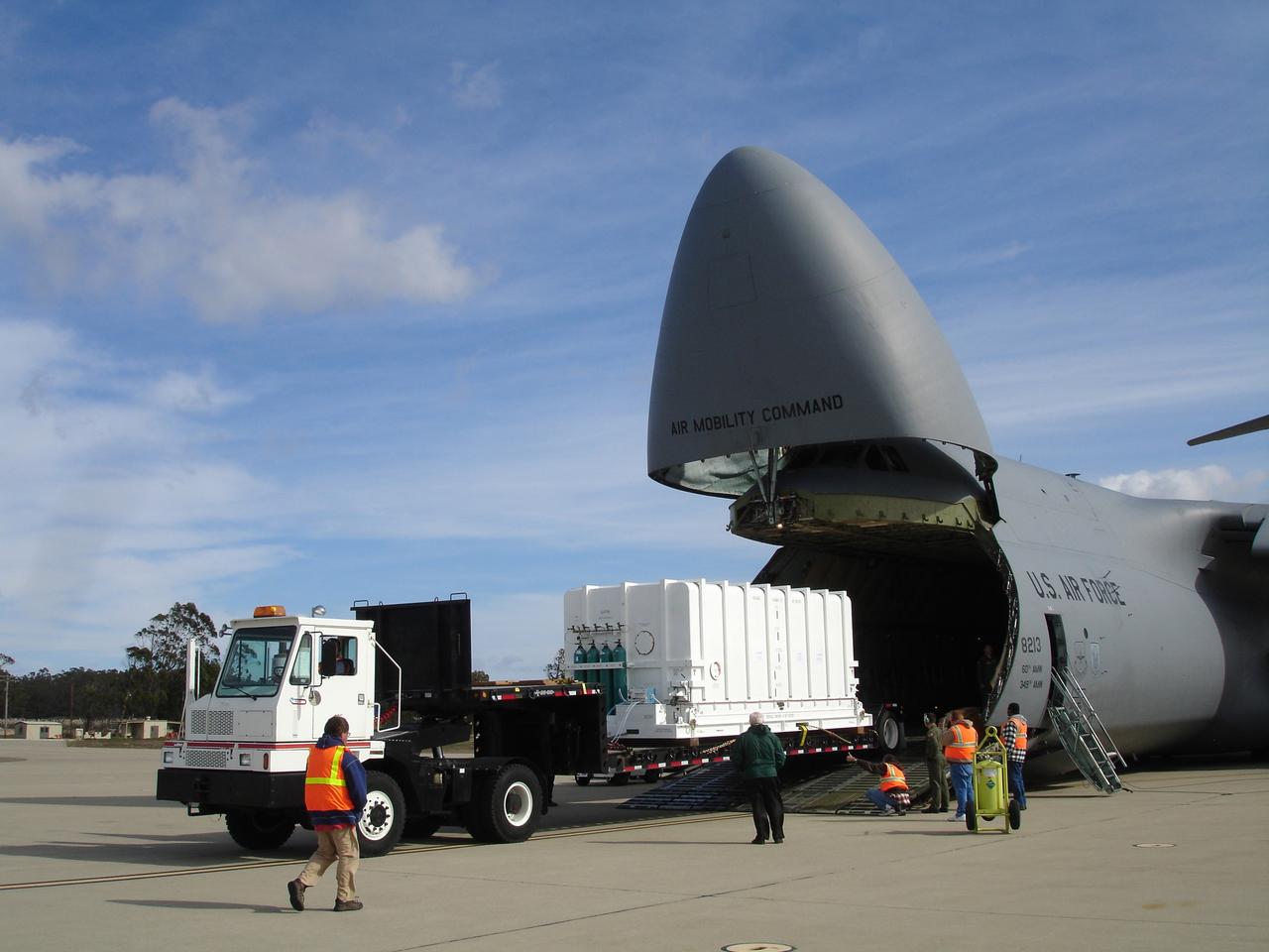 VANDENBERG AIR FORCE BASE, Calif. – The NOAA-N Prime spacecraft is offloaded from a C-5 aircraft after arrival at Vandenberg Air Force Base Airfield in California.  NOAA-N Prime was built by Lockheed Martin Space Systems Company for its  Advanced Television Infrared Observational Satellites -N series.  It is the latest polar-orbiting operational environmental weather satellite developed by NASA for the National Oceanic and Atmospheric Administration.  The satellite will provide a platform to support environmental monitoring instruments for imaging and measuring the Earth's atmosphere, its surface and cloud cover, including Earth radiation, atmospheric ozone, aerosol distribution, sea surface temperature and vertical temperature and water profiles in the troposphere and stratosphere. The satellite will assist in measuring proton and electron fluxes at orbit altitude, collecting data from remote platforms to assist the Search and Rescue Satellite-Aided Tracking system. The satellite will be launched from the Western Range at Vandenberg AFB by a United Launch Alliance two-stage Delta II rocket managed by NASA's Launch Service Program at Kennedy.  Photo credit: NASA/Jerry Nagy, VAFB