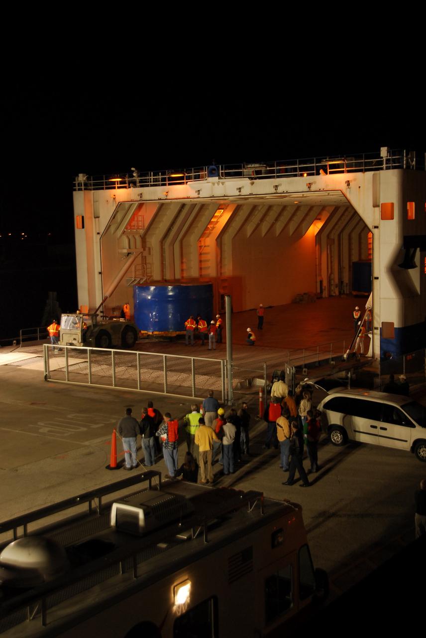 CAPE CANAVERAL, Fla. – The Ares I-X upper stage simulator segments are being offloaded from the Delta Mariner at Port Canaveral, Fla. The segments will be placed on a flatbed truck for transportation to the Vehicle Assembly Building's high bay 4 at NASA's Kennedy Space Center in Florida. The upper stage simulator will be used in the test flight identified as Ares I-X in 2009. The Ares I-X test flight will provide NASA an early opportunity to test and prove hardware, facilities and ground operations associated with the Ares I crew launch vehicle. It also will allow NASA to gather critical data during ascent of the integrated Orion crew exploration vehicle and the Ares I rocket. The data will ensure the entire vehicle system is safe and fully operational before astronauts begin traveling to orbit. The simulator segments will simulate the mass and the outer mold line and will be more than 100 feet of the total vehicle height of 327 feet. The simulator comprises 11 segments that are approximately 18 feet in diameter. Most of the segments will be approximately 10 feet high, ranging in weight from 18,000 to 60,000 pounds, for a total of approximately 450,000 pounds. Photo credit: NASA/Cory Huston