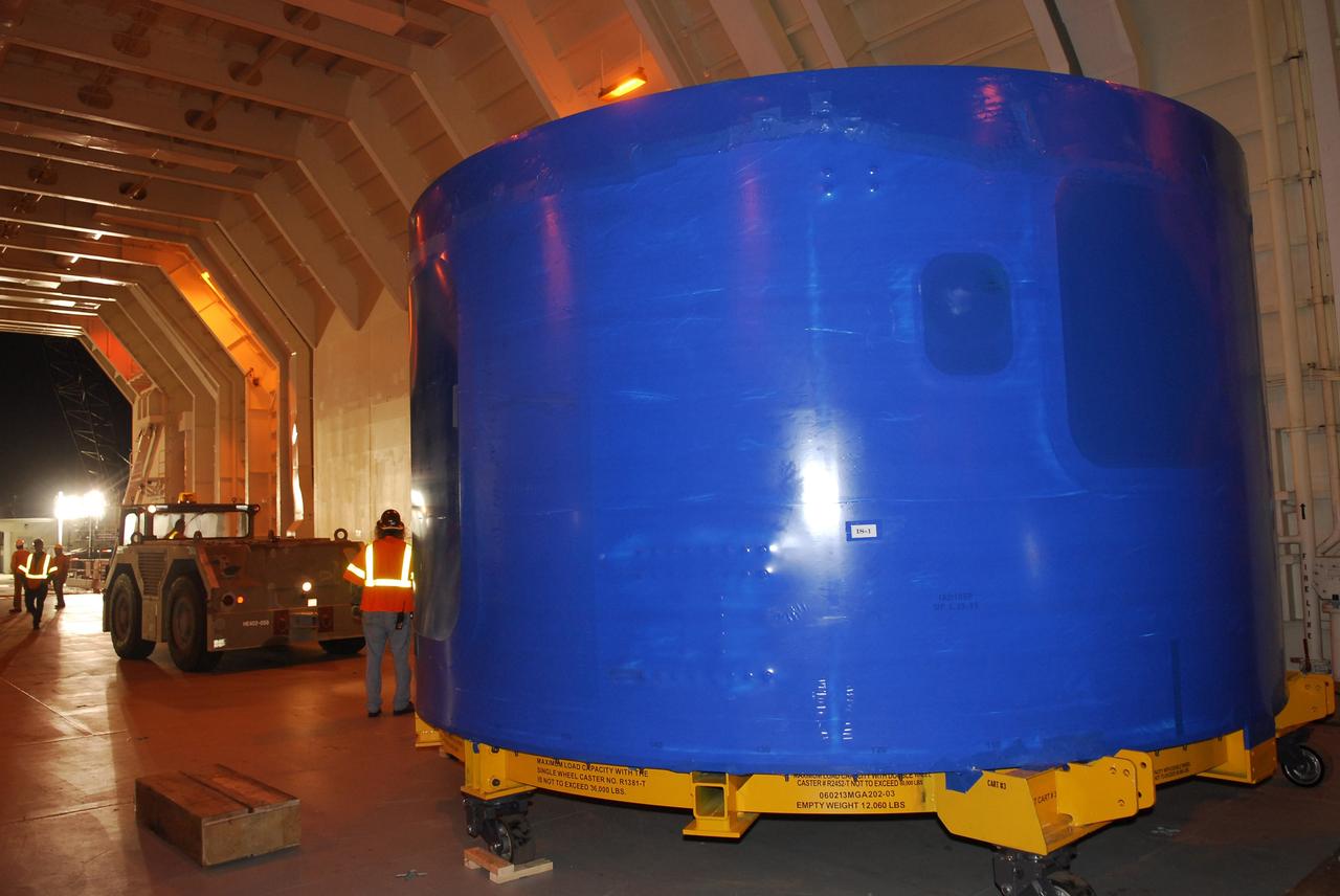 CAPE CANAVERAL, Fla. – At Port Canaveral, Fla., the Ares I-X upper stage simulator segments are being offloaded from the Delta Mariner. The segments will be placed on a flatbed truck for transportation to the Vehicle Assembly Building's high bay 4 at NASA's Kennedy Space Center in Florida. The upper stage simulator will be used in the test flight identified as Ares I-X in 2009. The Ares I-X test flight will provide NASA an early opportunity to test and prove hardware, facilities and ground operations associated with the Ares I crew launch vehicle. It also will allow NASA to gather critical data during ascent of the integrated Orion crew exploration vehicle and the Ares I rocket. The data will ensure the entire vehicle system is safe and fully operational before astronauts begin traveling to orbit. The simulator segments will simulate the mass and the outer mold line and will be more than 100 feet of the total vehicle height of 327 feet. The simulator comprises 11 segments that are approximately 18 feet in diameter. Most of the segments will be approximately 10 feet high, ranging in weight from 18,000 to 60,000 pounds, for a total of approximately 450,000 pounds. Photo credit: NASA/Cory Huston