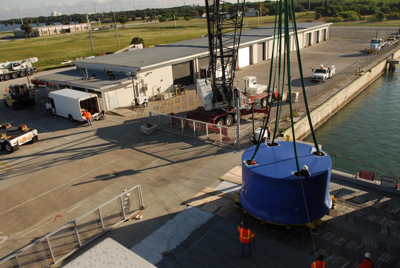 CAPE CANAVERAL, Fla. – Ares I-X upper stage simulator segments arrive at the Vehicle Assembly Building's high bay 4 at NASA's Kennedy Space Center in Florida. The upper stage simulator will be used in the test flight identified as Ares I-X in 2009. The Ares I-X test flight will provide NASA an early opportunity to test and prove hardware, facilities and ground operations associated with the Ares I crew launch vehicle. It also will allow NASA to gather critical data during ascent of the integrated Orion crew exploration vehicle and the Ares I rocket. The data will ensure the entire vehicle system is safe and fully operational before astronauts begin traveling to orbit. The simulator segments will simulate the mass and the outer mold line and will be more than 100 feet of the total vehicle height of 327 feet. The simulator comprises 11 segments that are approximately 18 feet in diameter. Most of the segments will be approximately 10 feet high, ranging in weight from 18,000 to 60,000 pounds, for a total of approximately 450,000 pounds. Photo credit: NASA/Cory Huston