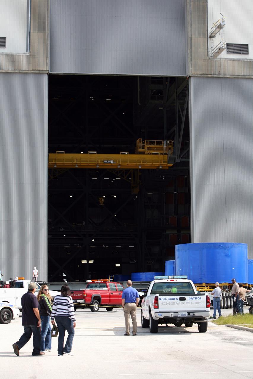 CAPE CANAVERAL, Fla. – At the Vehicle Assembly Building's high bay 4 at NASA's Kennedy Space Center in Florida, the blue Ares I-X upper stage simulator segments are moved inside where they will be offloaded. The upper stage simulators will be used in the test flight identified as Ares I-X in 2009. The Ares I-X test flight will provide NASA an early opportunity to test and prove hardware, facilities and ground operations associated with the Ares I crew launch vehicle. It also will allow NASA to gather critical data during ascent of the integrated Orion crew exploration vehicle and the Ares I rocket. The data will ensure the entire vehicle system is safe and fully operational before astronauts begin traveling to orbit. The simulator segments will simulate the mass and the outer mold line and will be more than 100 feet of the total vehicle height of 327 feet. The simulator comprises 11 segments that are approximately 18 feet in diameter. Most of the segments will be approximately 10 feet high, ranging in weight from 18,000 to 60,000 pounds, for a total of approximately 450,000 pounds. Photo credit: NASA/Cory Huston