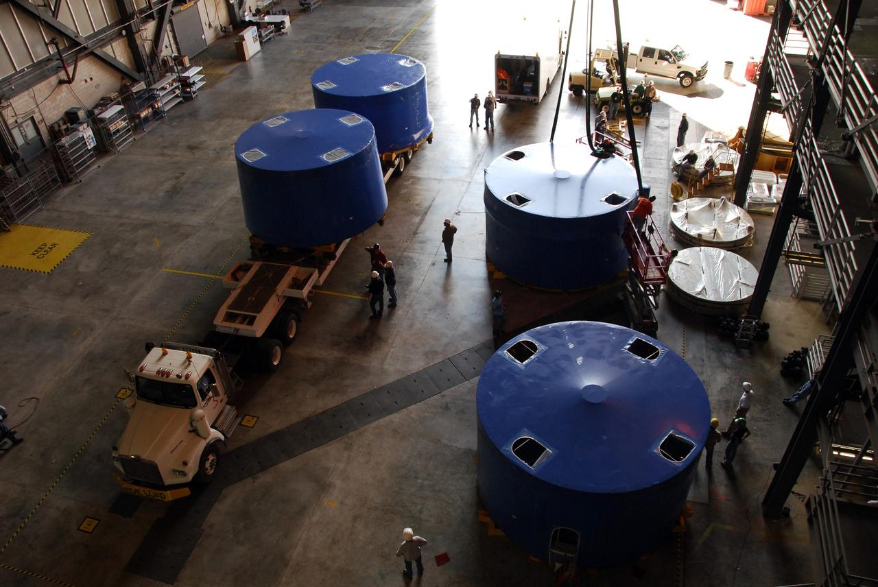 CAPE CANAVERAL, Fla. – Inside the Vehicle Assembly Building's high bay 4 at NASA's Kennedy Space Center in Florida, Ares I-X upper stage simulator segments are being offloaded onto the floor. The segments arrived Nov. 4 at Port Canaveral, Fla., aboard the Delta Mariner. The upper simulator segments are moved inside where they will be offloaded. The upper stage simulators will be used in the test flight identified as Ares I-X in 2009. The Ares I-X test flight will provide NASA an early opportunity to test and prove hardware, facilities and ground operations associated with the Ares I crew launch vehicle. It also will allow NASA to gather critical data during ascent of the integrated Orion crew exploration vehicle and the Ares I rocket. The data will ensure the entire vehicle system is safe and fully operational before astronauts begin traveling to orbit. The simulator segments will simulate the mass and the outer mold line and will be more than 100 feet of the total vehicle height of 327 feet. The simulator comprises 11 segments that are approximately 18 feet in diameter. Most of the segments will be approximately 10 feet high, ranging in weight from 18,000 to 60,000 pounds, for a total of approximately 450,000 pounds. Photo credit: NASA/Cory Huston