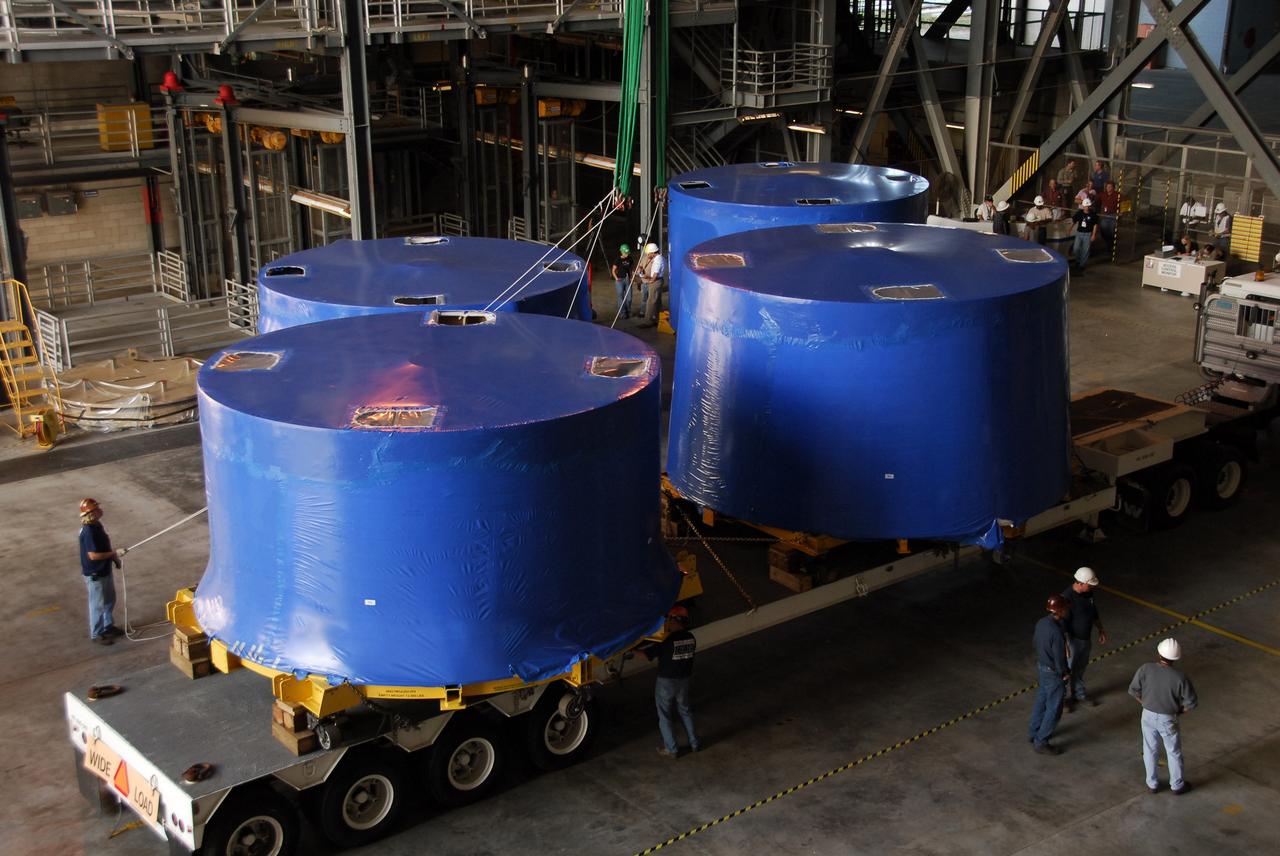 CAPE CANAVERAL, Fla. – Inside the Vehicle Assembly Building's high bay 4 at NASA's Kennedy Space Center in Florida, Ares I-X upper stage simulator segments are being offloaded onto the floor. The segments arrived Nov. 4 at Port Canaveral, Fla., aboard the Delta Mariner. The upper simulator segments are moved inside where they will be offloaded. The upper stage simulators will be used in the test flight identified as Ares I-X in 2009. The Ares I-X test flight will provide NASA an early opportunity to test and prove hardware, facilities and ground operations associated with the Ares I crew launch vehicle. It also will allow NASA to gather critical data during ascent of the integrated Orion crew exploration vehicle and the Ares I rocket. The data will ensure the entire vehicle system is safe and fully operational before astronauts begin traveling to orbit. The simulator segments will simulate the mass and the outer mold line and will be more than 100 feet of the total vehicle height of 327 feet. The simulator comprises 11 segments that are approximately 18 feet in diameter. Most of the segments will be approximately 10 feet high, ranging in weight from 18,000 to 60,000 pounds, for a total of approximately 450,000 pounds. Photo credit: NASA/Cory Huston